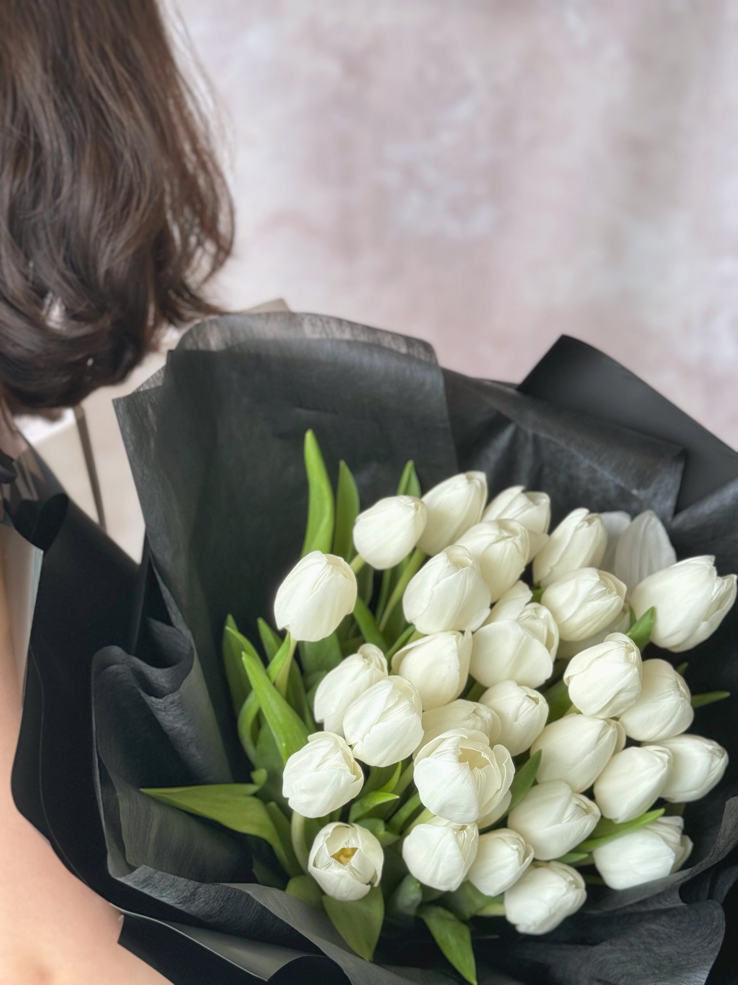 Close up view of a sleek white tulips bouquet