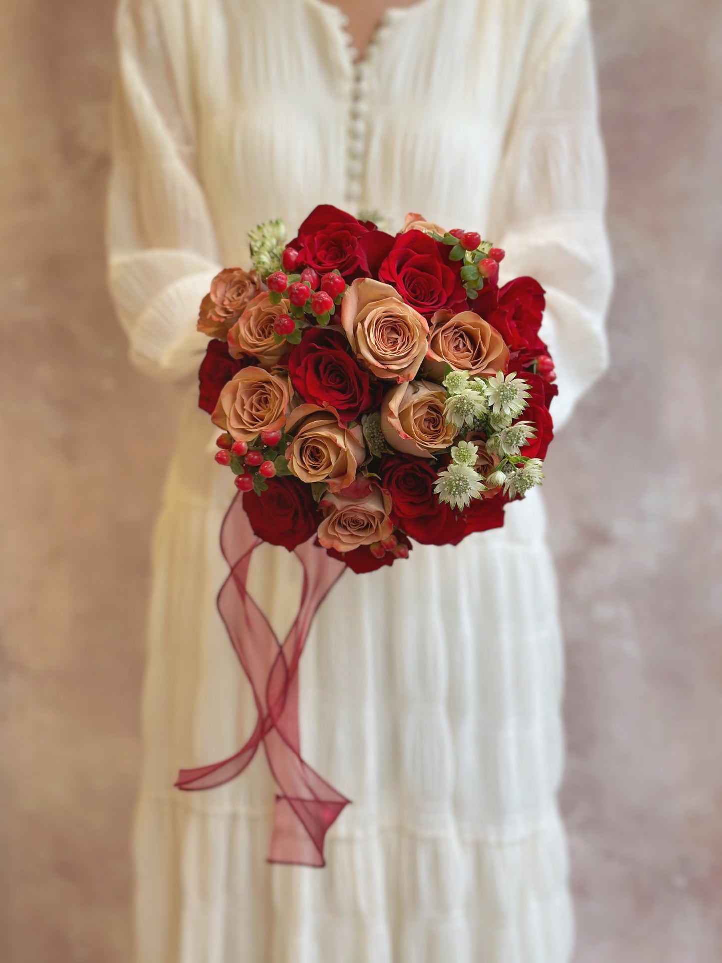 A close-up view highlighting the round bouquet’s balanced floral arrangement, showcasing the intricate details of each bloom.
特写展现圆形捧花的均衡花艺设计,捕捉每朵花的精致细节。