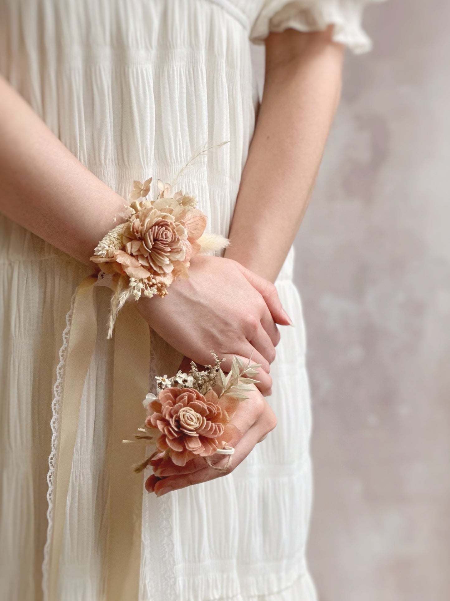 Model wearing Coco bali corsage set on wrists.