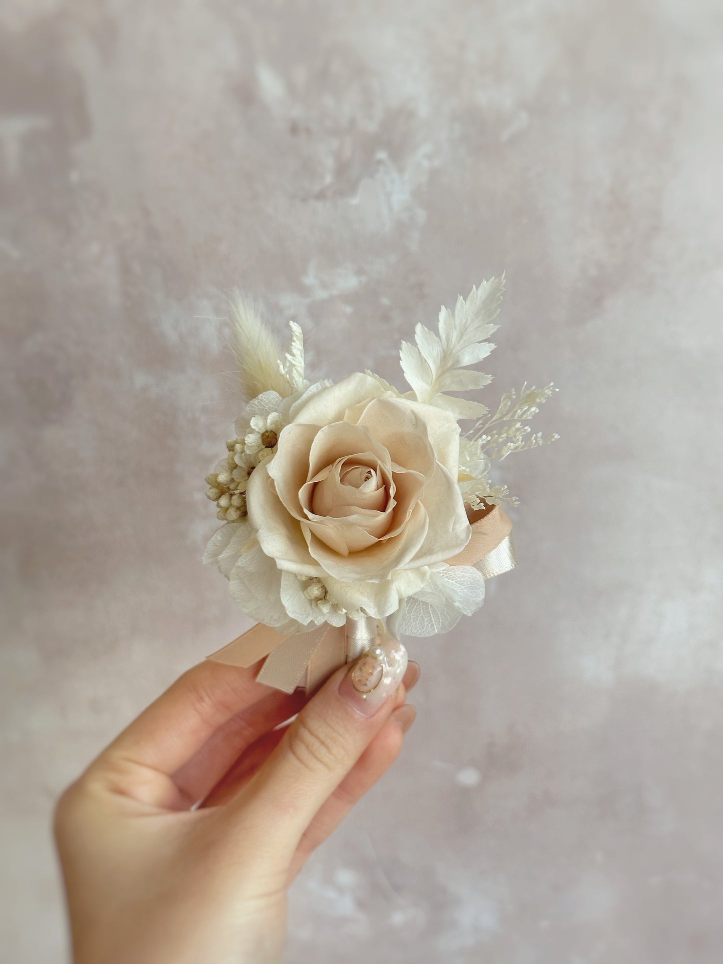 Holding Creme preserved rose corsage, perfect for nude or white theme wedding or events!