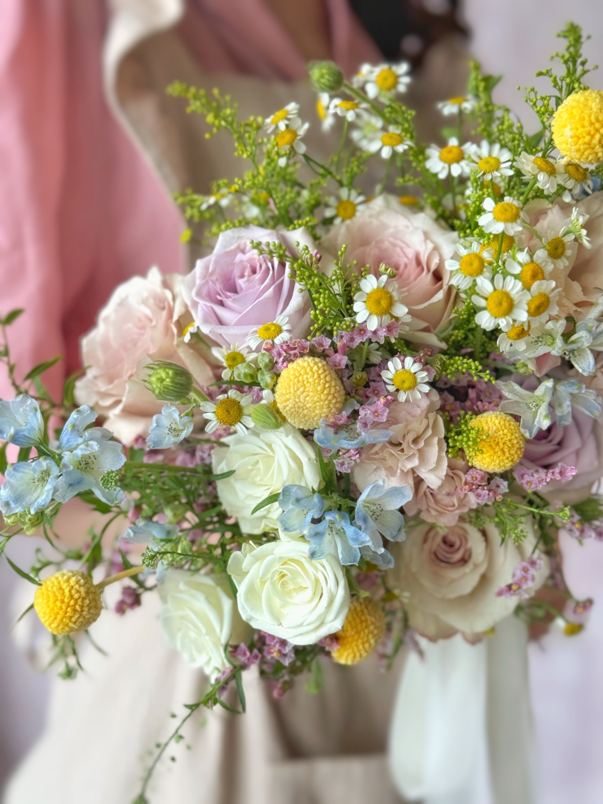 Dorothea fresh flowers bridal bouquet, Soft pastel roses in lilac, green, yellow, blue, and pink, captured in a close-up to showcase their intricate beauty