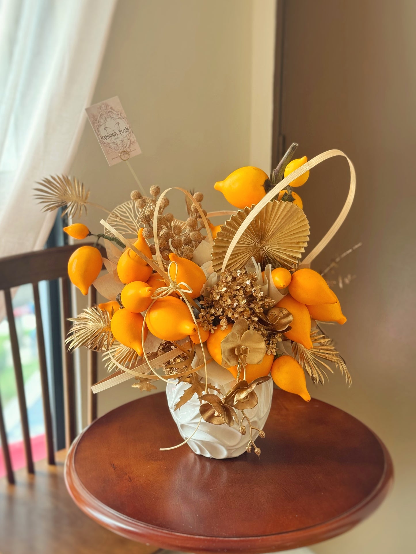 close up view of chinese new year floral gift with nipplefruits, golden ornaments in vase, designed for home decoration and prosperity blessings.