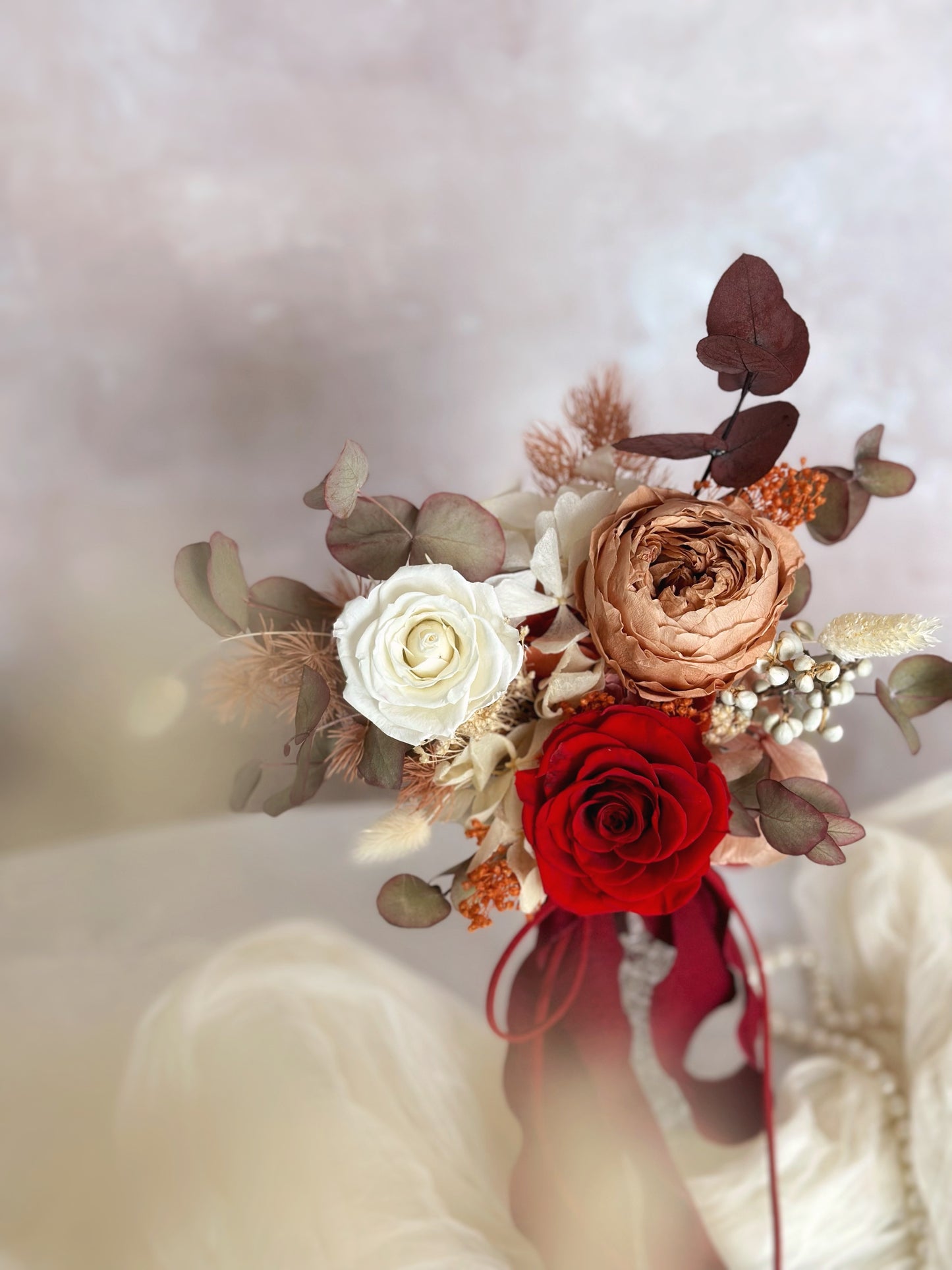 Close up view of preserved flowers bridal bouquet in adorable size. Featuring preserved Austin roses and other fillers