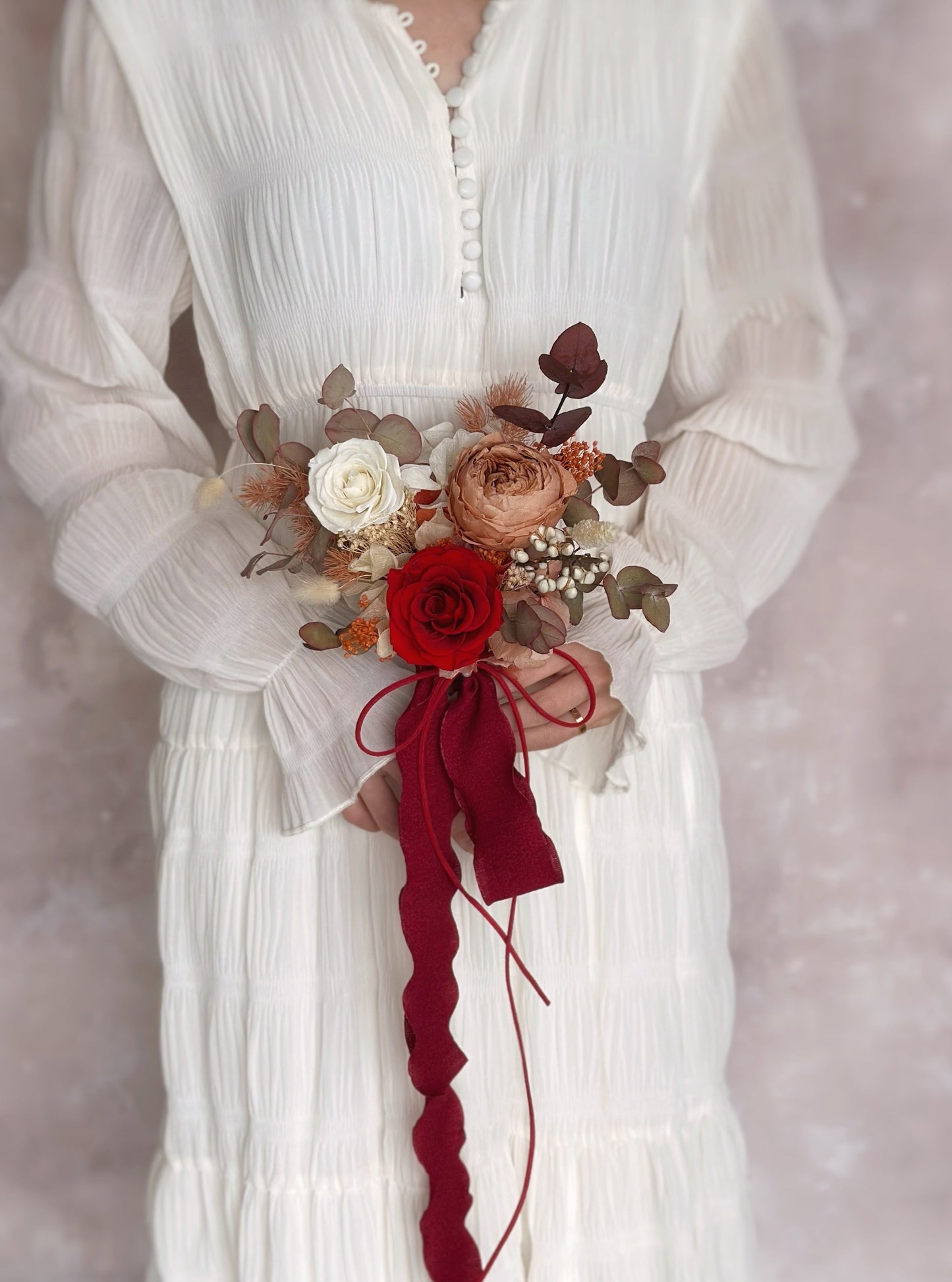 Holding a small (adorable size) preserved flowers bridal bouquet in autumnal theme