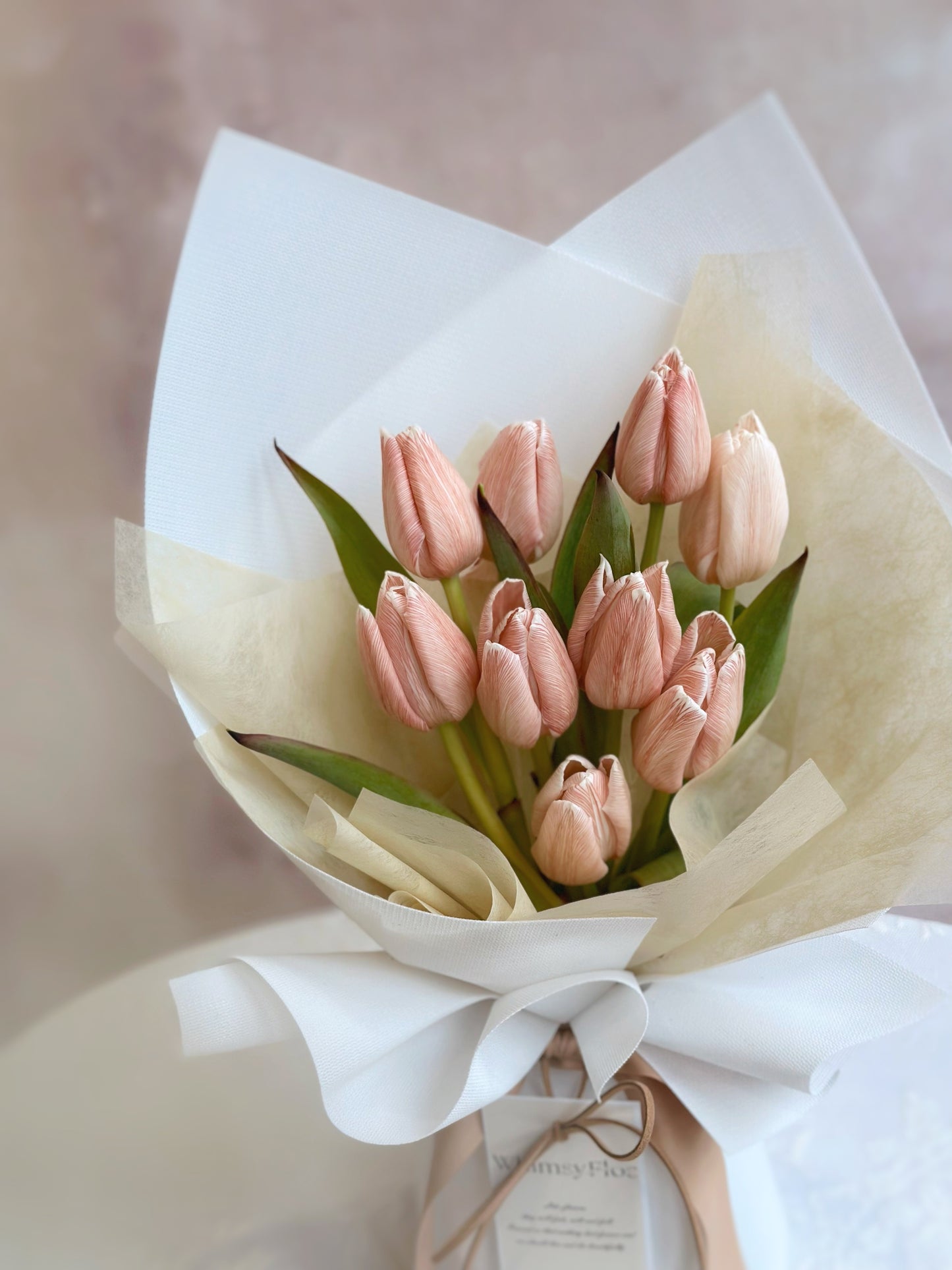 Close up view of a light tone brownie coloured stem dyed tulips bouquet