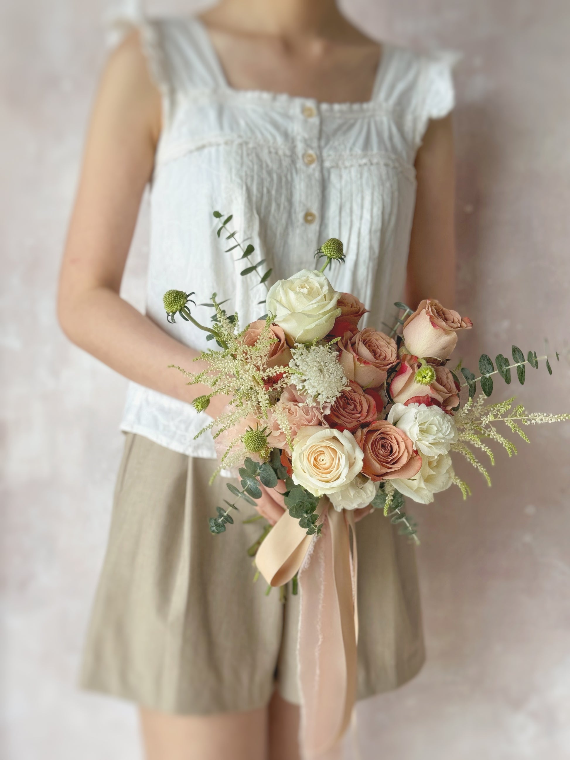 Isabella fresh flowers bridal bouquet holding the bouquet grand size, a stunning mix of cappuccino roses, astilbe, and greenery in a natural fan shape, ideal for brides seeking a timeless yet effortless floral design
