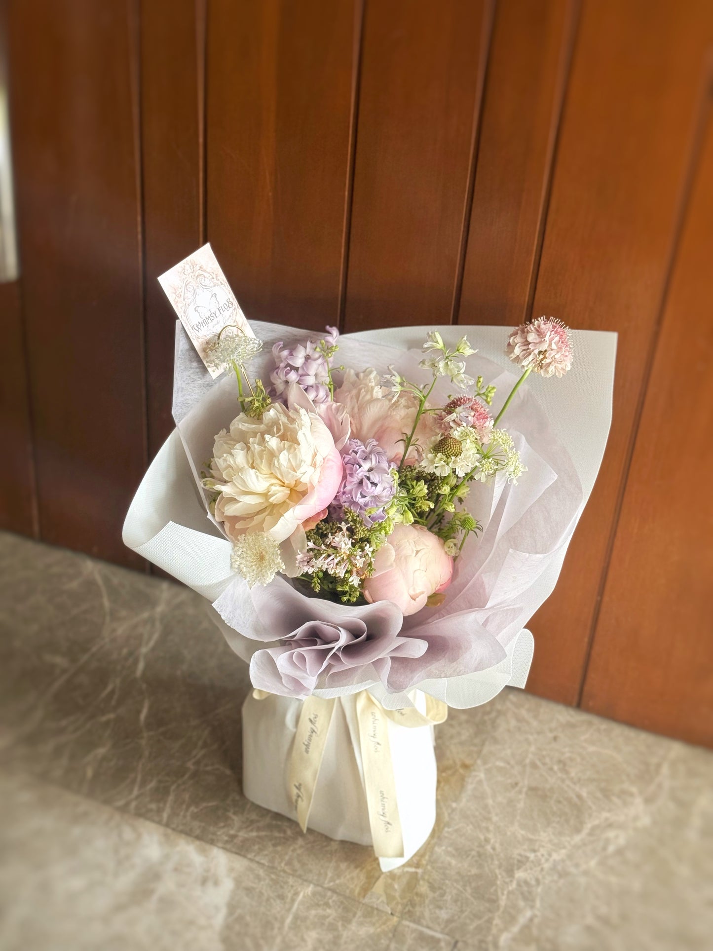 Top-down view of bouquet showing balanced, airy floral arrangement in dreamy lilac and ivory hues.
俯视图呈现淡紫与象牙白的梦幻搭配,整体布局轻盈且协调。