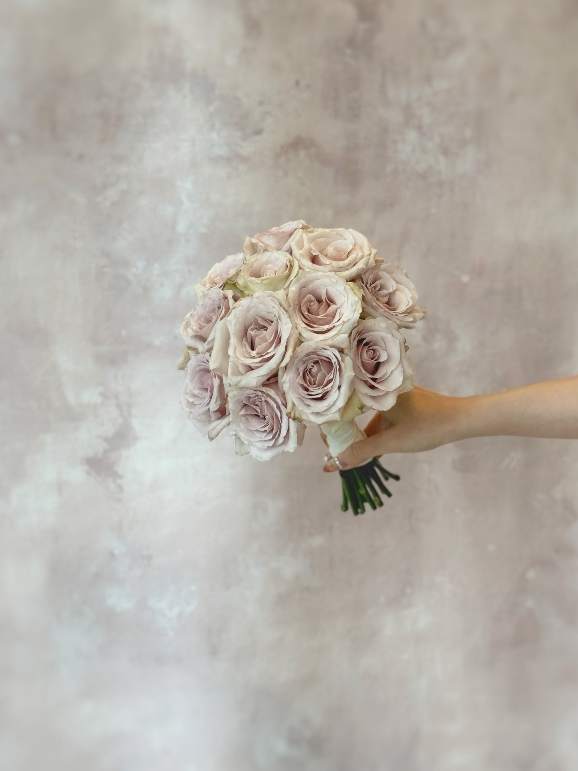 Only quicksand roses round shaped bridal_bouquet_holding the bouquet