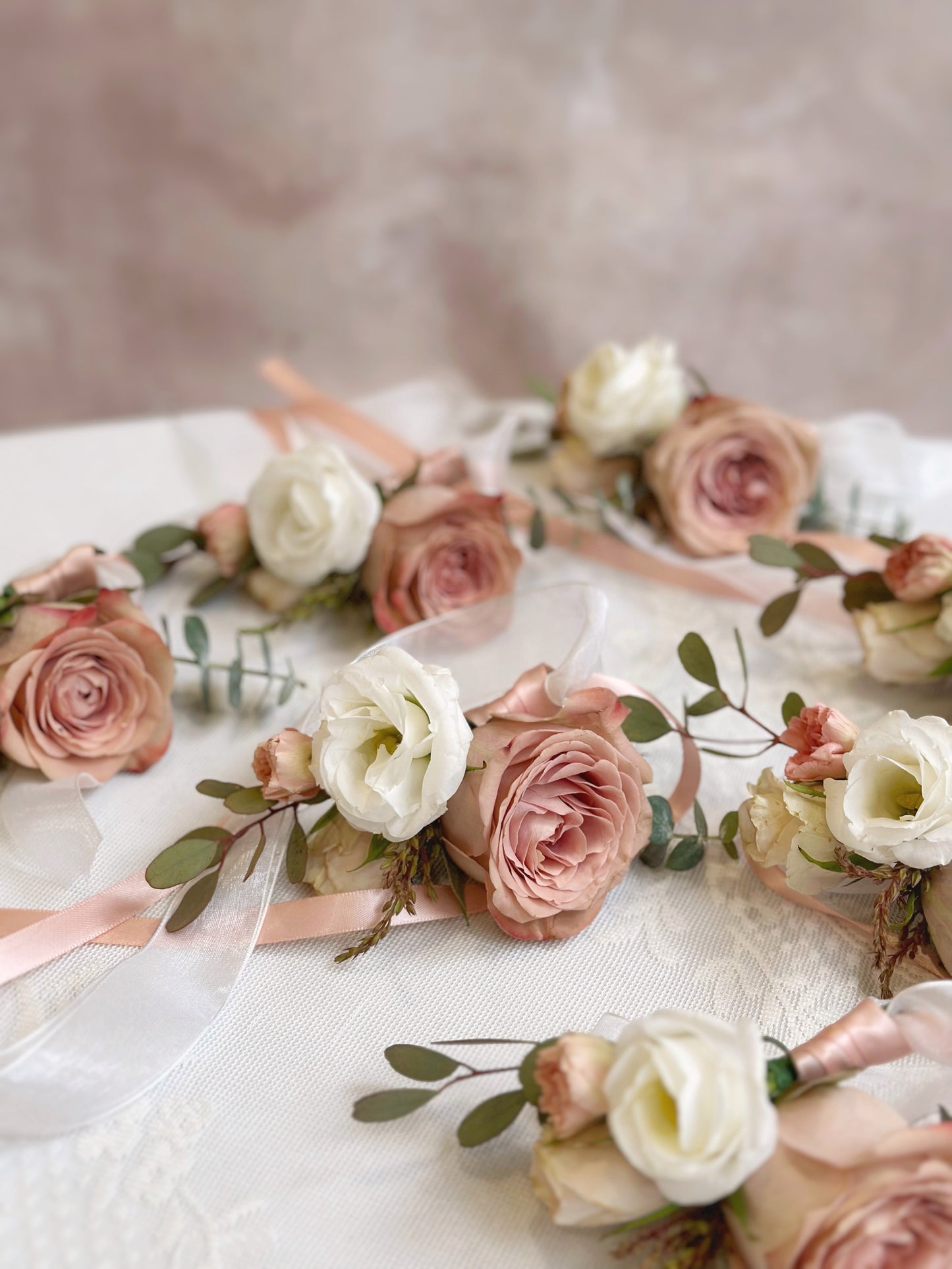 Close up view of rose douce fresh cappuccino rose wrist corsages in bulk for wedding and other occasions
