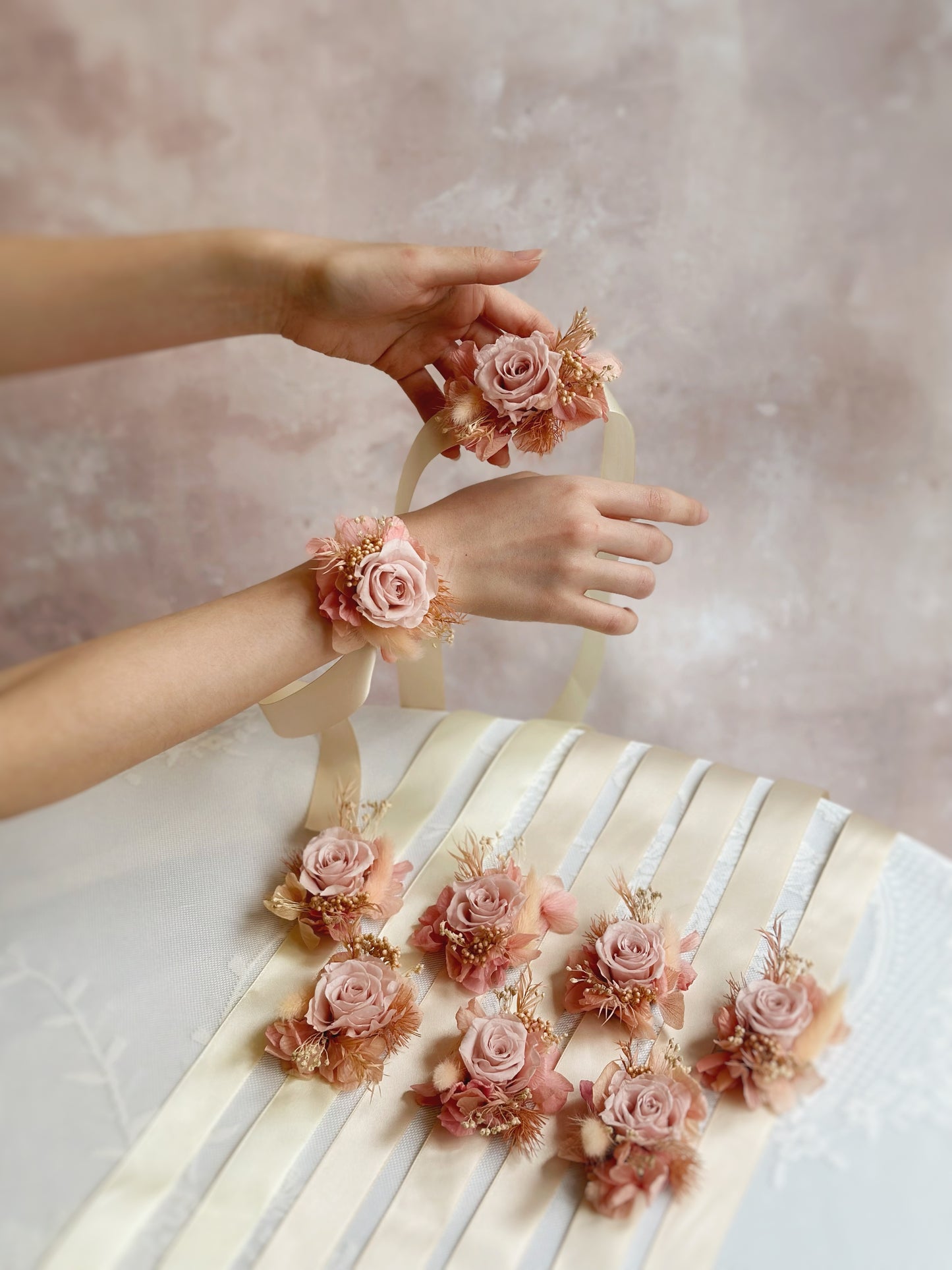 Step into your fairy-tale moment with these enchanting floral accessories. Here is a photo showing our Tiana preserved flowers boutonniere and wrist corsage.