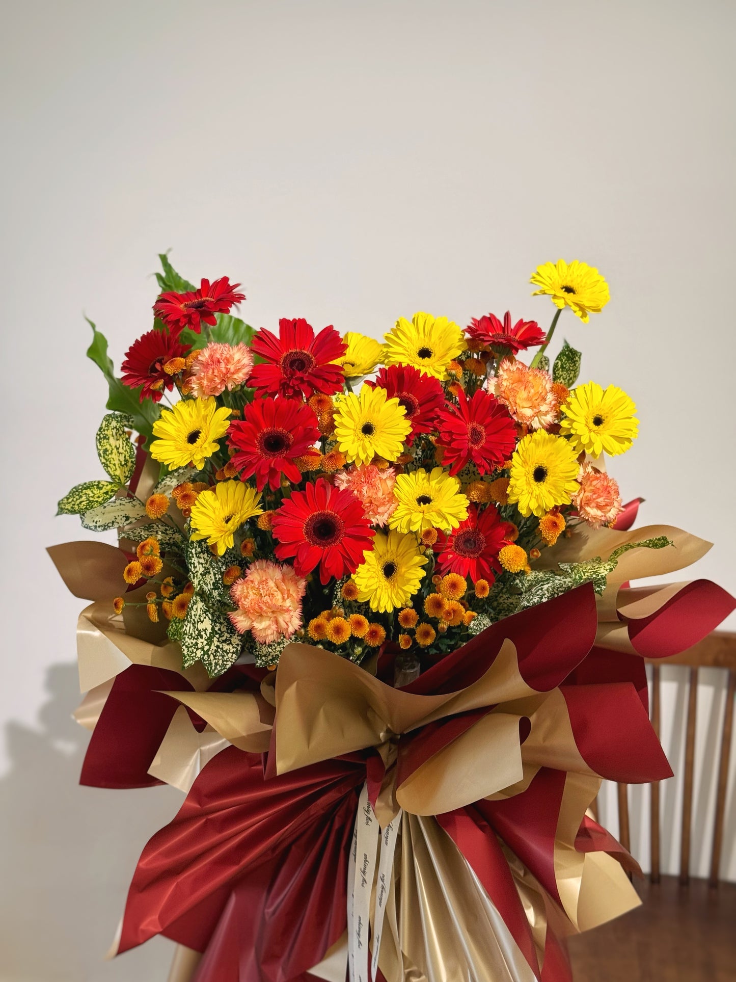 close up view of whimsy flos studio gerbera flowers grand opening stand in red and yellow colour theme