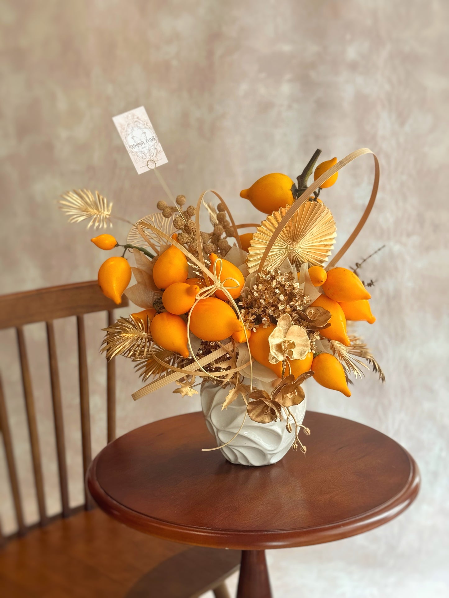 top view of cny vase arrangement, showcasing vibrant golden yellow nipplefruits.
