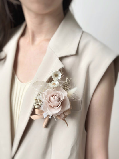 Elegant ivory tone preserved rose boutonniere for the groom, showing it worn on a khaki blazer