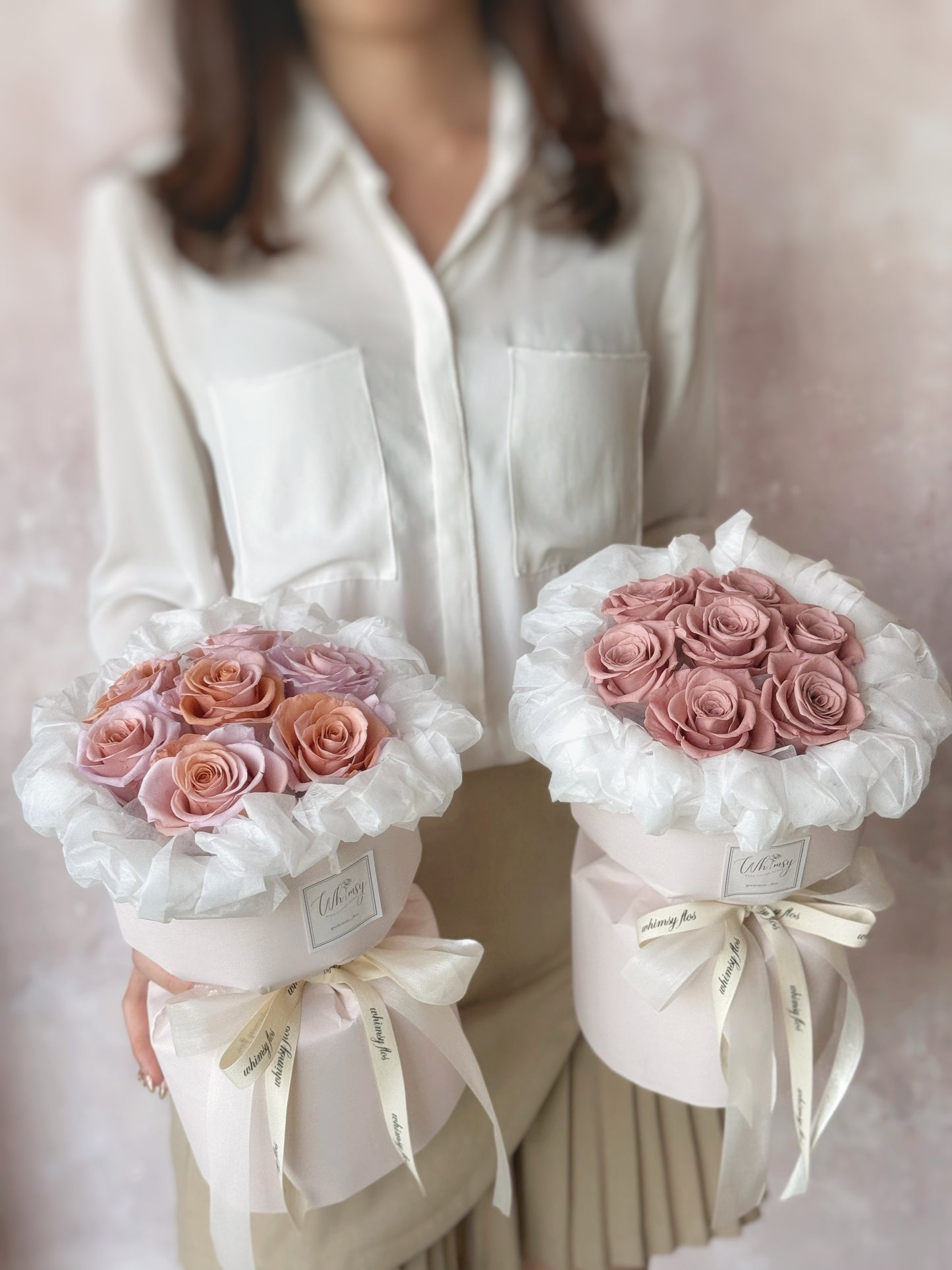 Holding two different Anya preserved flowers round bouquet for comparison 