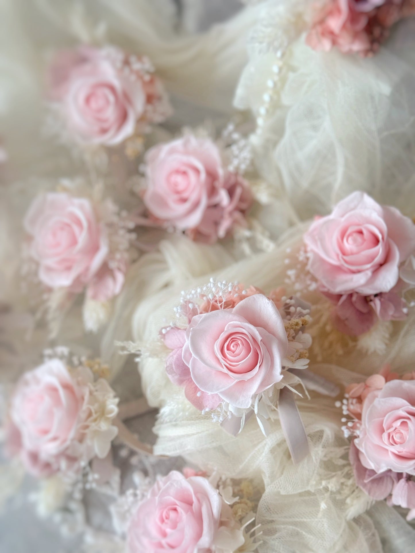 a scattering of pink preserved flowers boutonnieres, each one a tiny work of art. 