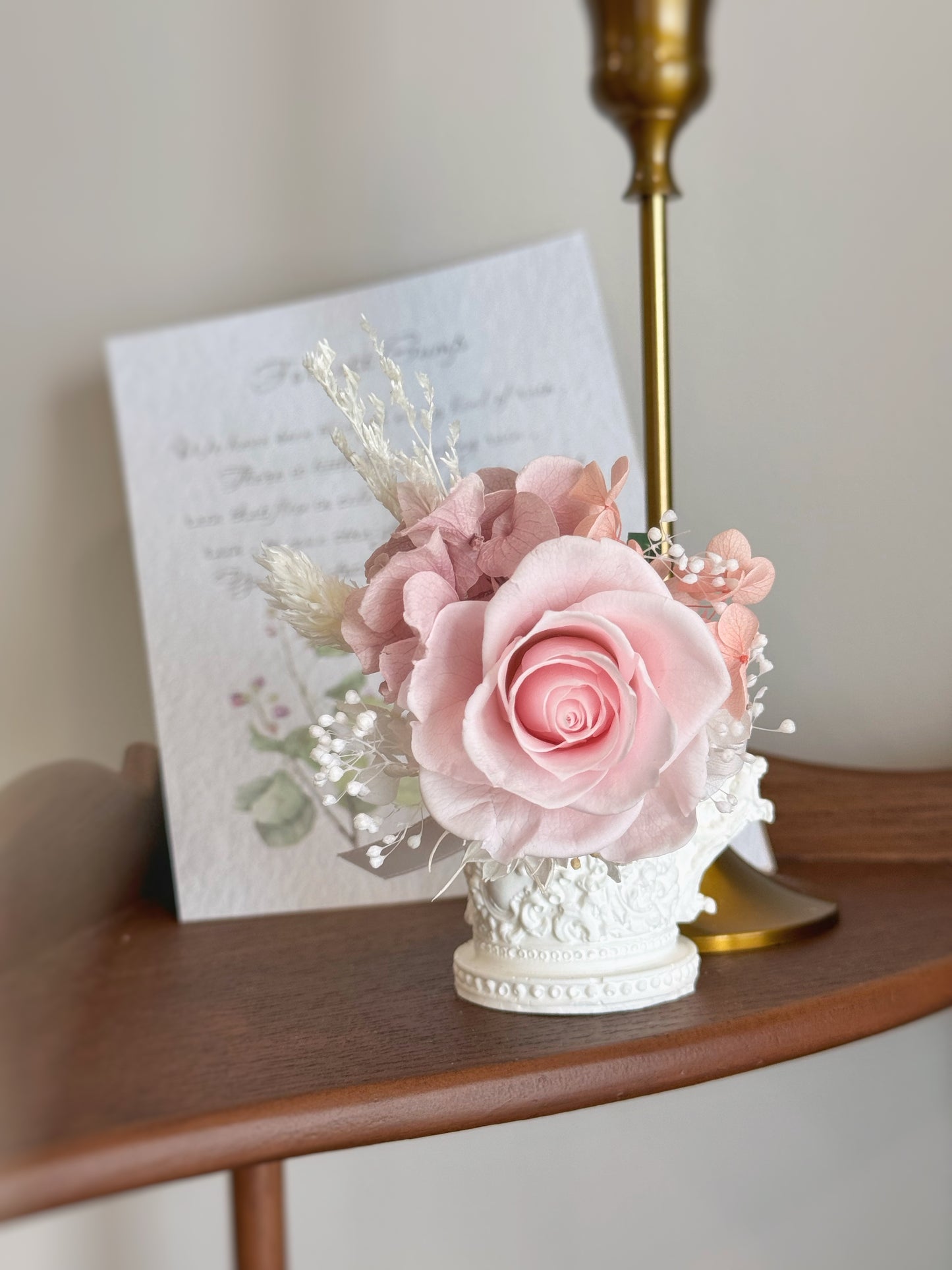 Pastel pink single preserved rose boutonniere accented by pure white and cream color preserved fillers.