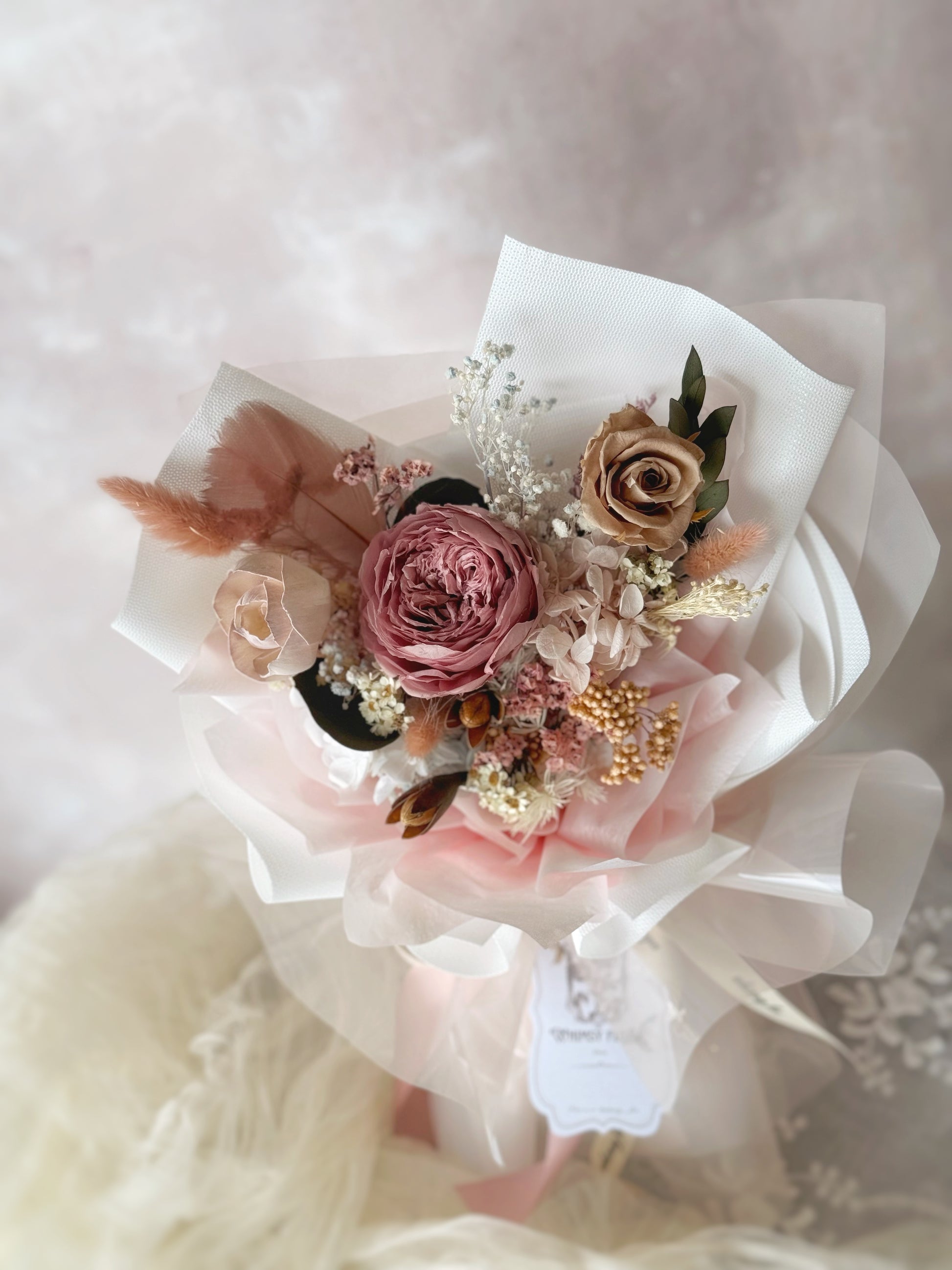 Close up photo of a dusty pink preserved Austin rose bouquet 