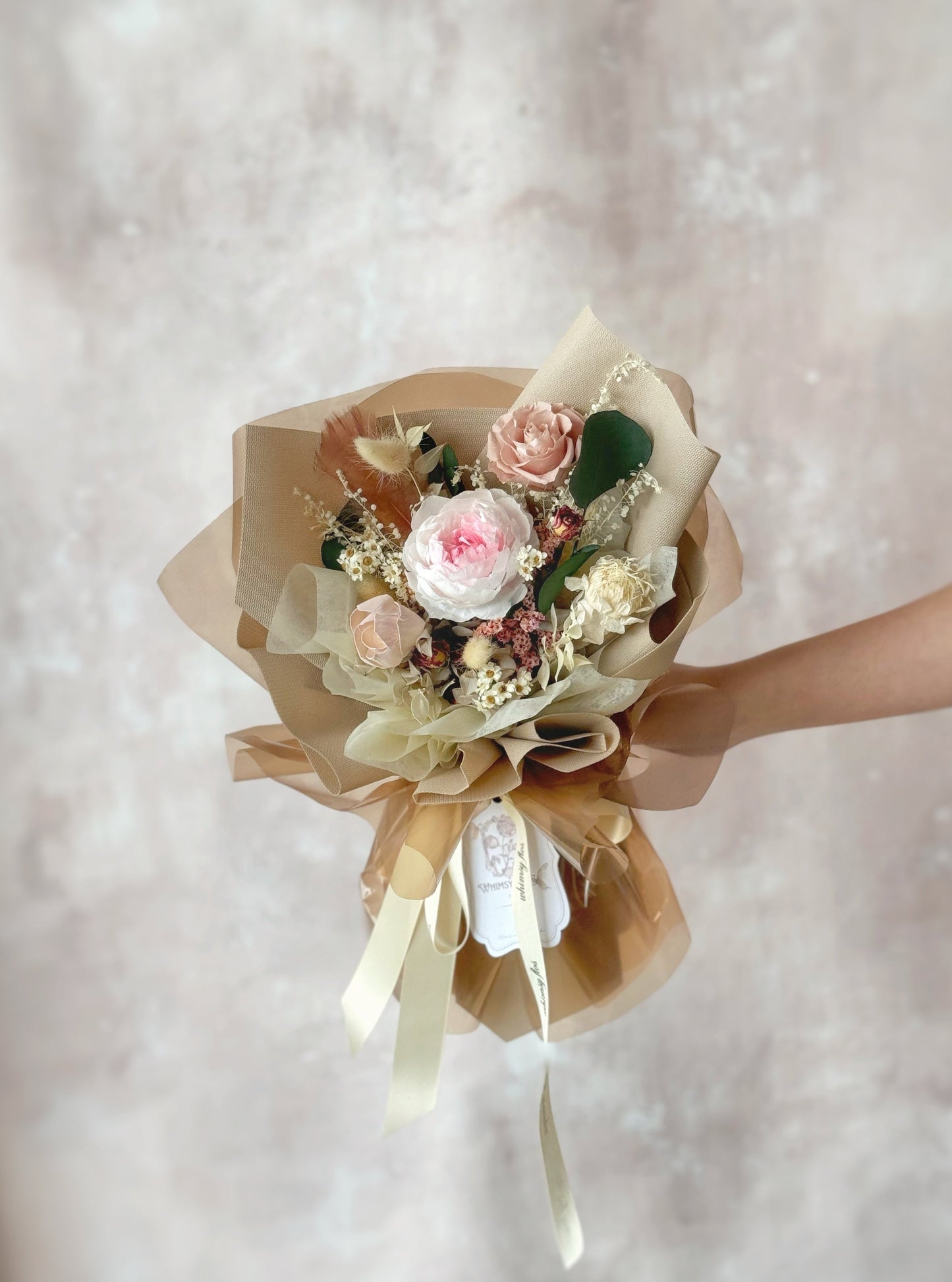 Vintage themed preserved flowers bouquet handheld front view