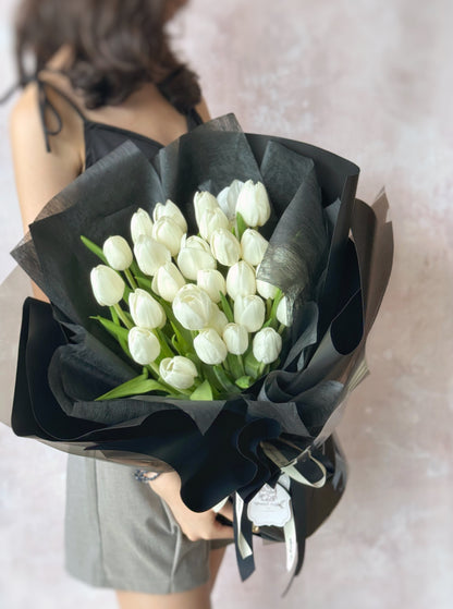 Bentley fresh flowers handtied bouquet holding by model 3 stalks of white tulips