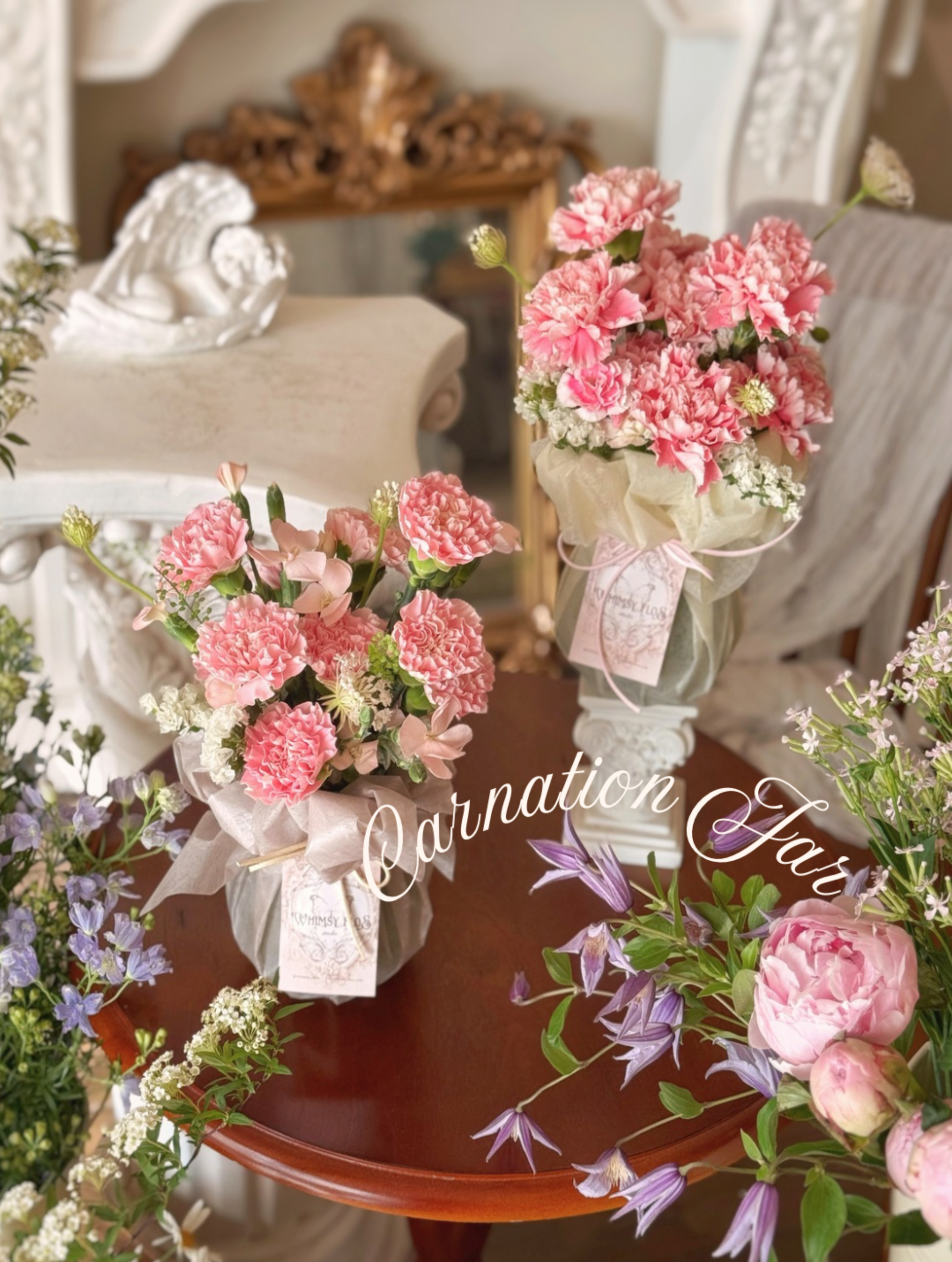Bouquets of pink carnations on a wooden table with decorative elements.