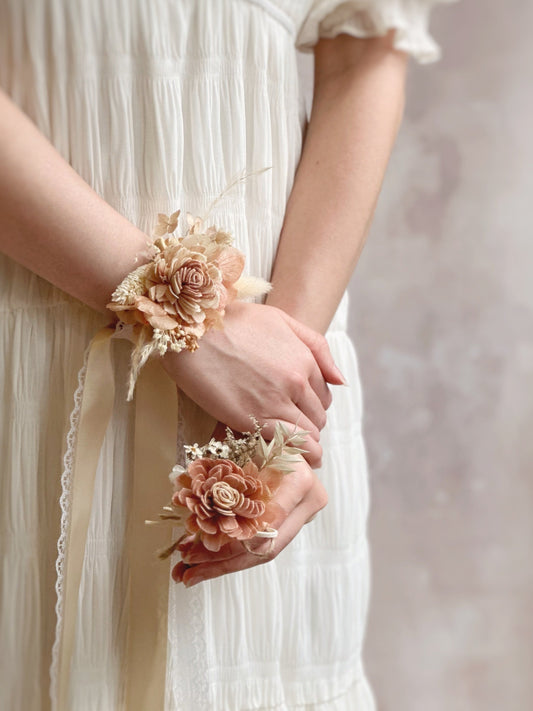 Model wearing Coco bali corsage set on wrists. 