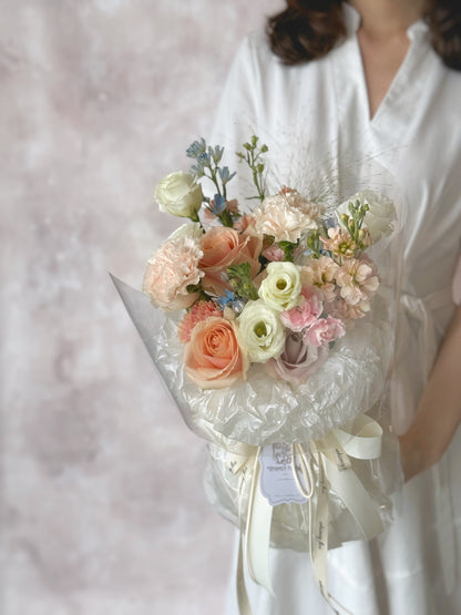 Colette fresh flowers fluffy cloud handtied luxe size bouquet holding by a model