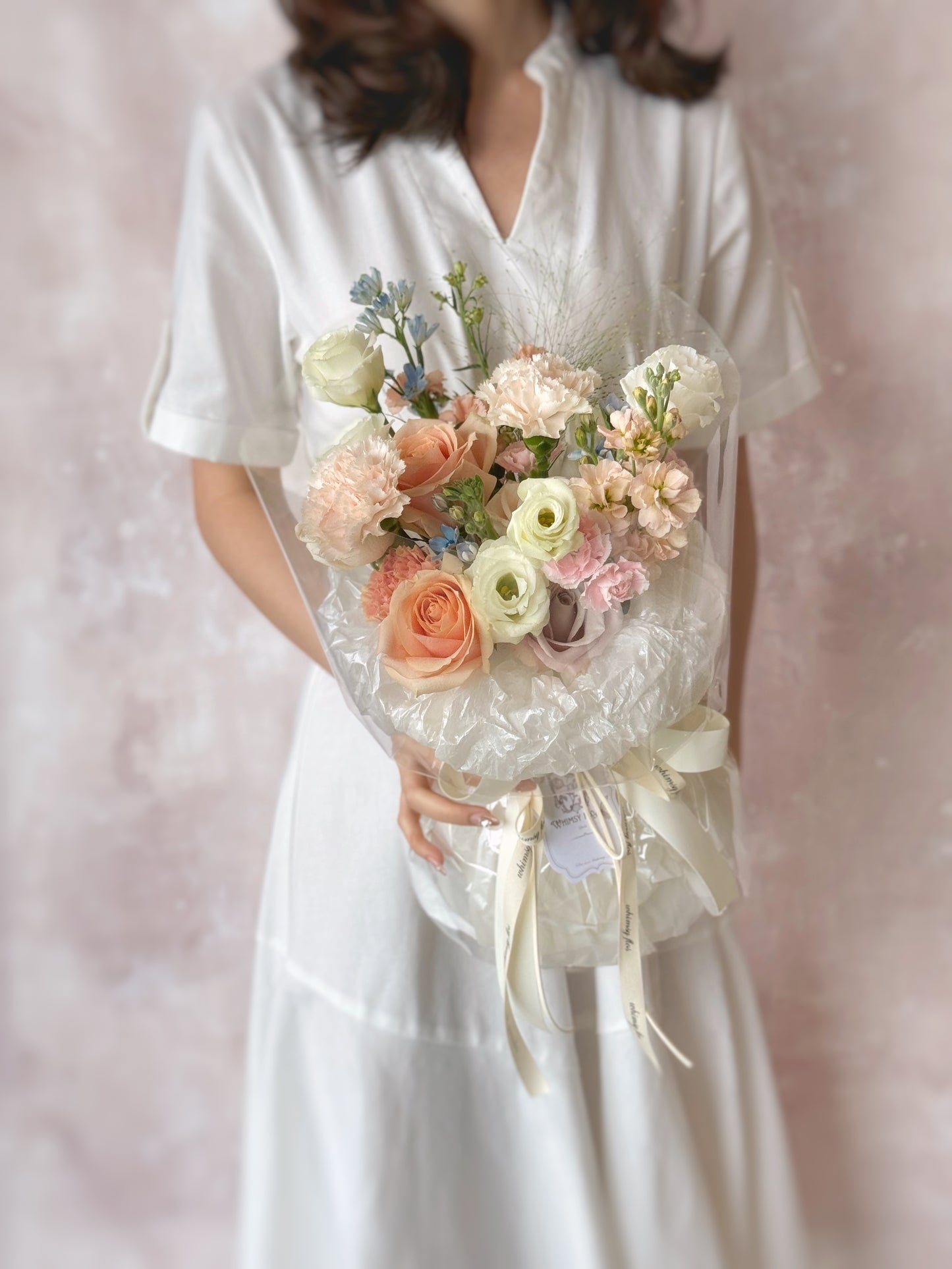 Colette_fresh_flowers_fluffy_cloud_handtied_bouquet holding by model