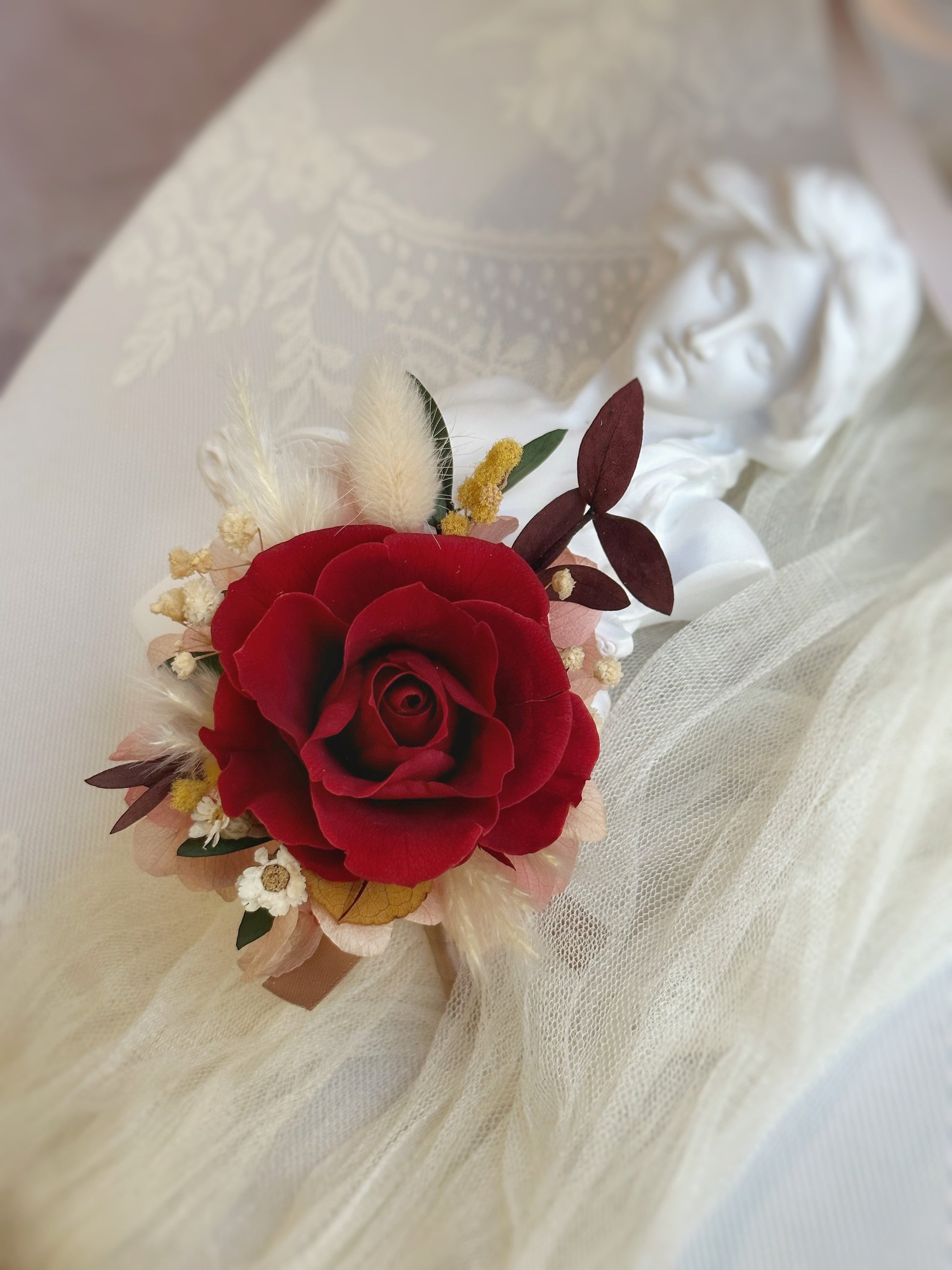 Close up view of crimson heart red preserved rose boutonniere