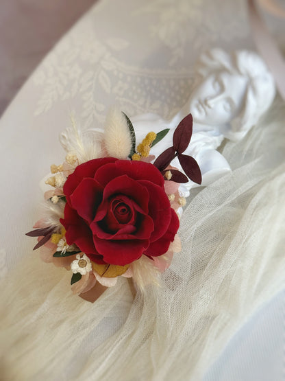 Close up view of crimson heart red preserved rose boutonniere