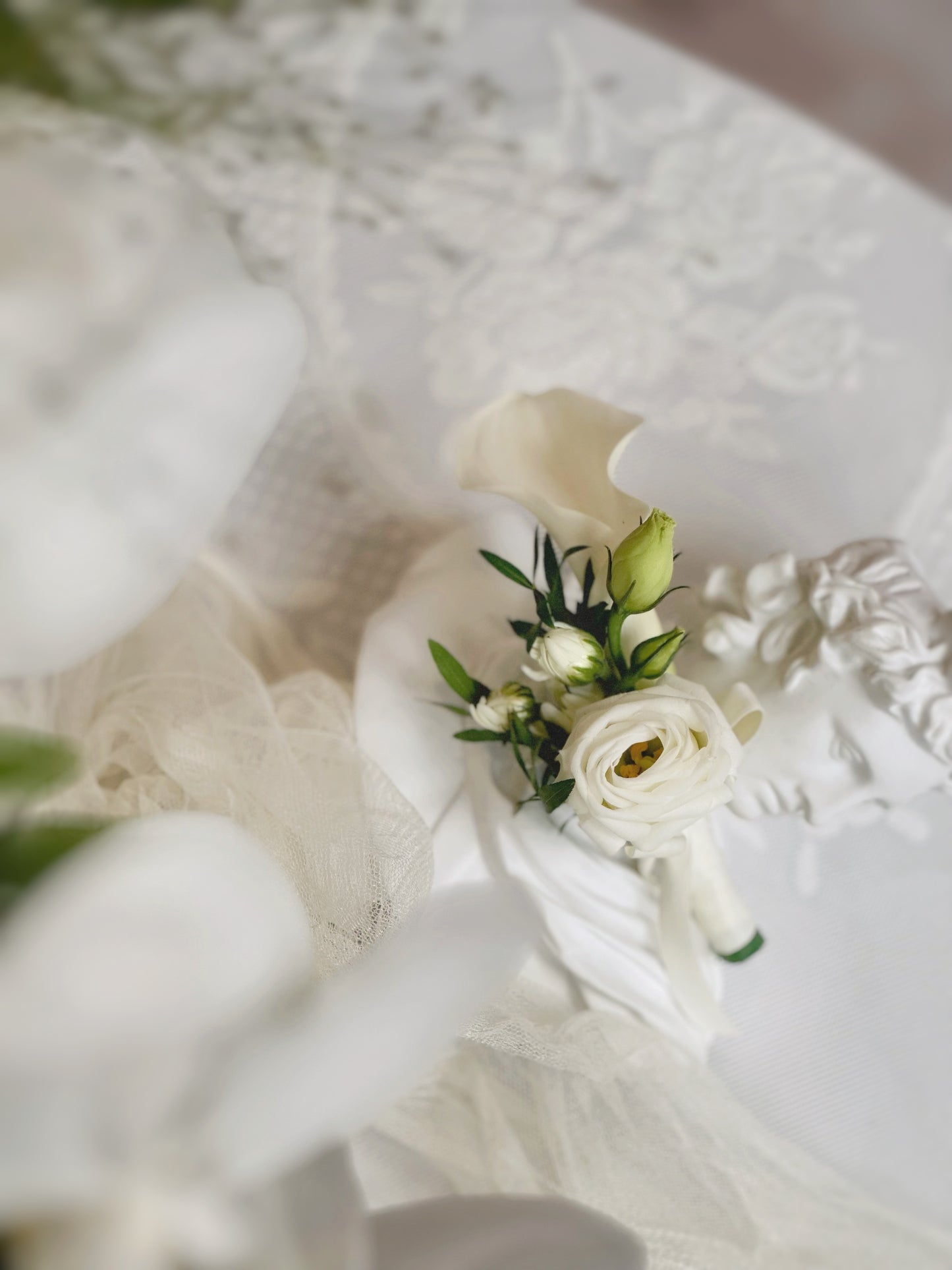 front view of delicate touch white calla lily corsage, this design matches beautifully with our teardrop bridal bouquet