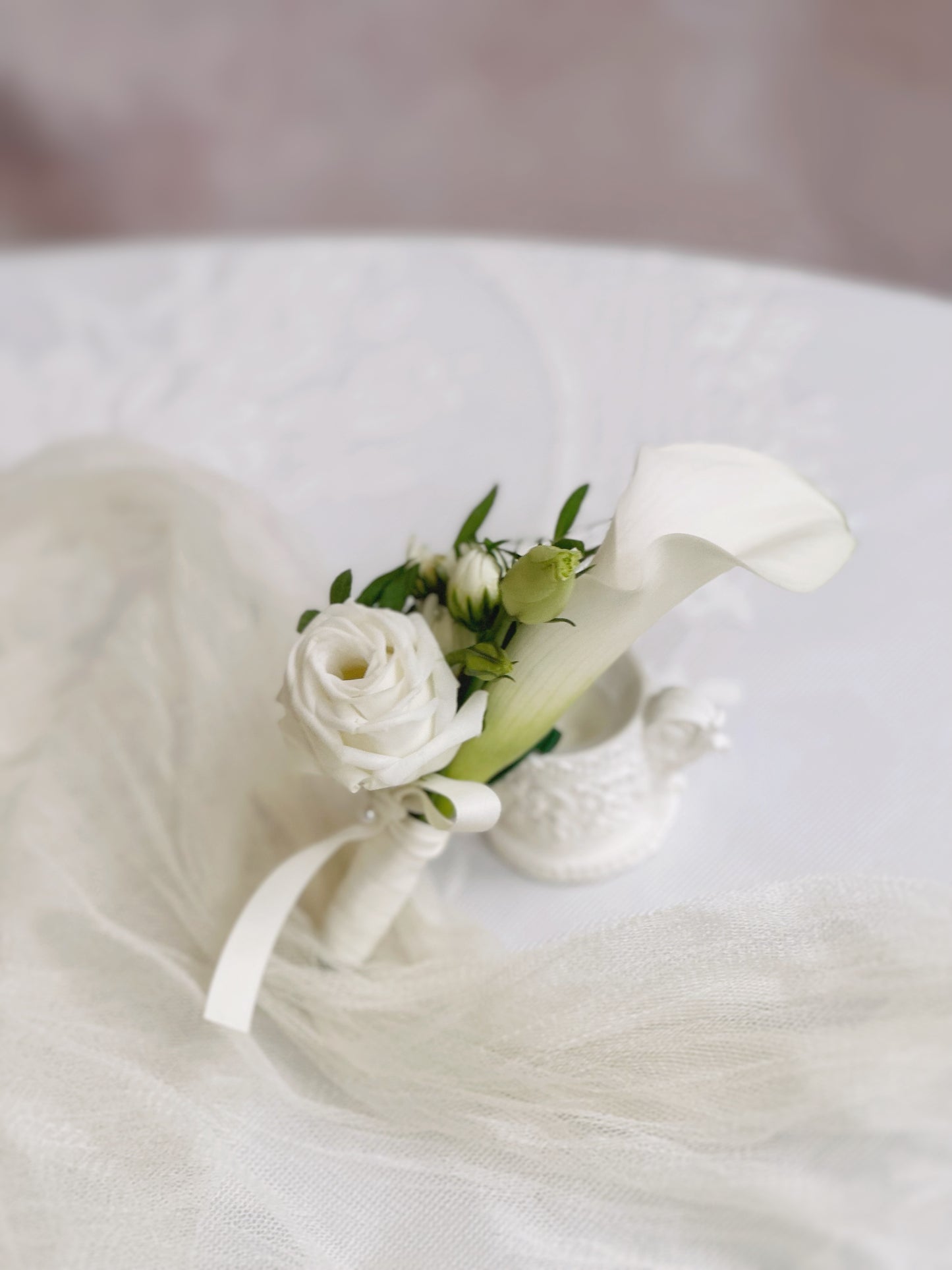 Side view of delicate touch white calla lily corsage