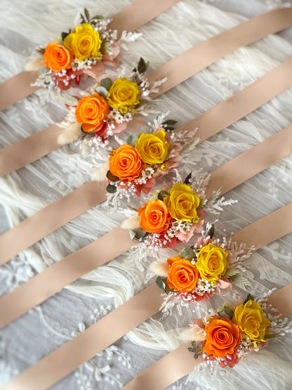 top view of double tansy preserved flowers wrist corsage lying elegantly on the table