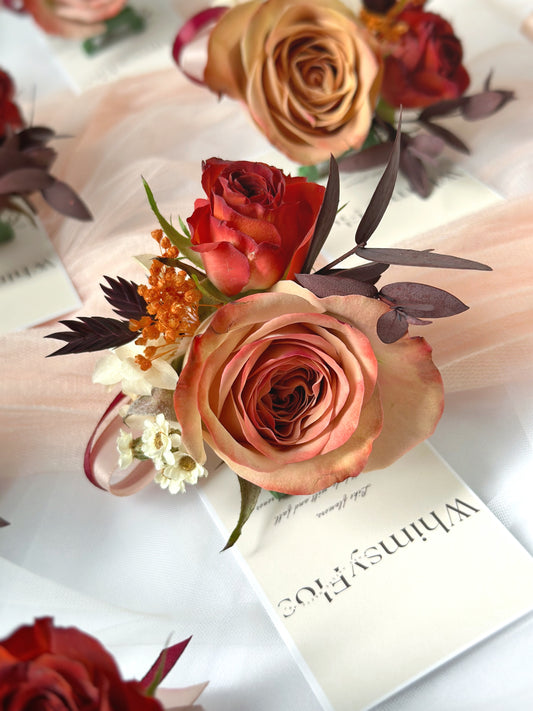 Close up view of Faye fresh flowers cappuccino rose corsage, accented with chocolate bubble spray rose, and assorted preserved flowers in autumnal theme.