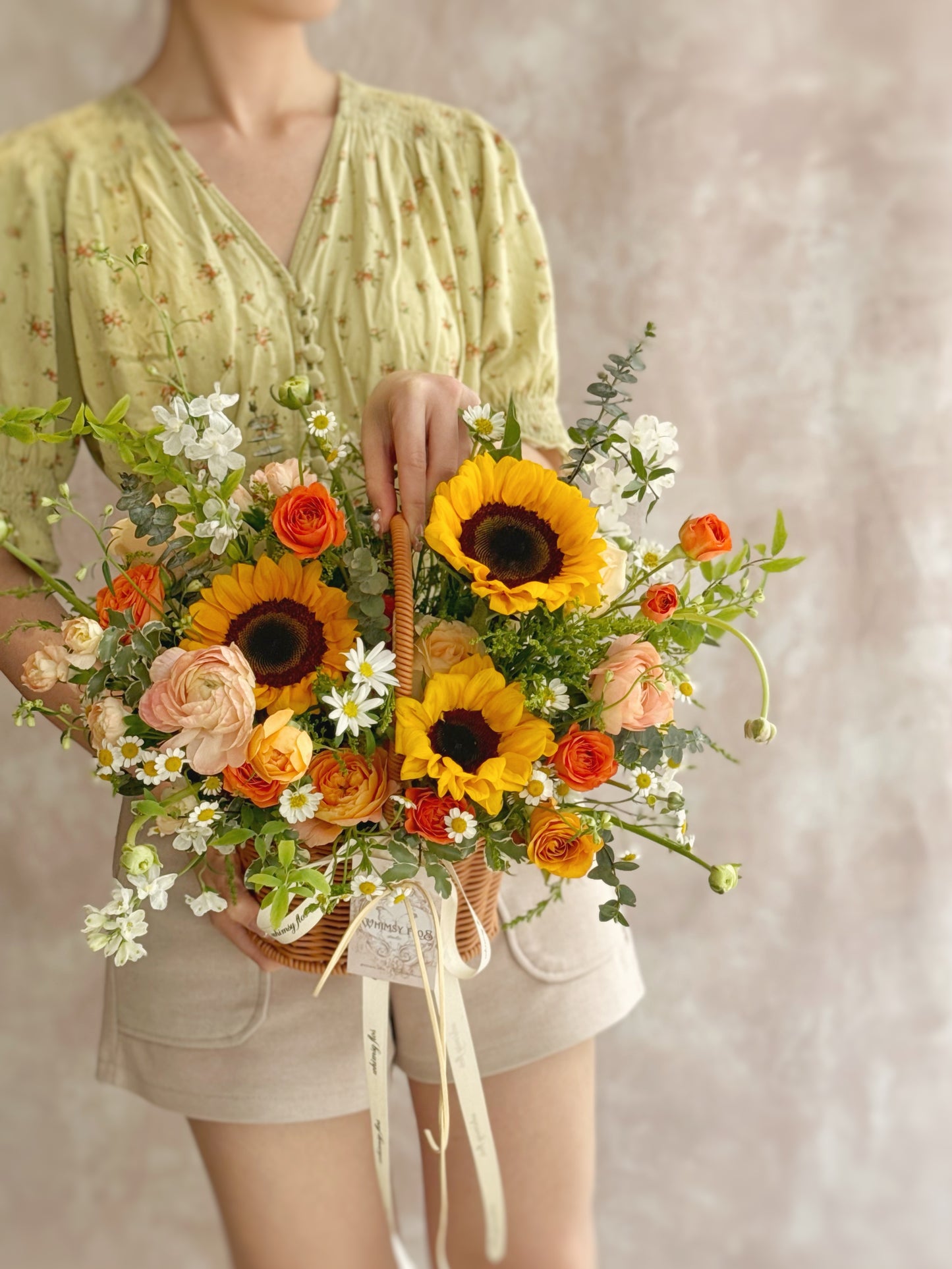 Basket held by model, capturing the cheerful, sunlit energy of the floral design in a joyful real-life setting.

模特手持花篮，记录阳光花艺的温暖活力与真实的愉悦氛围