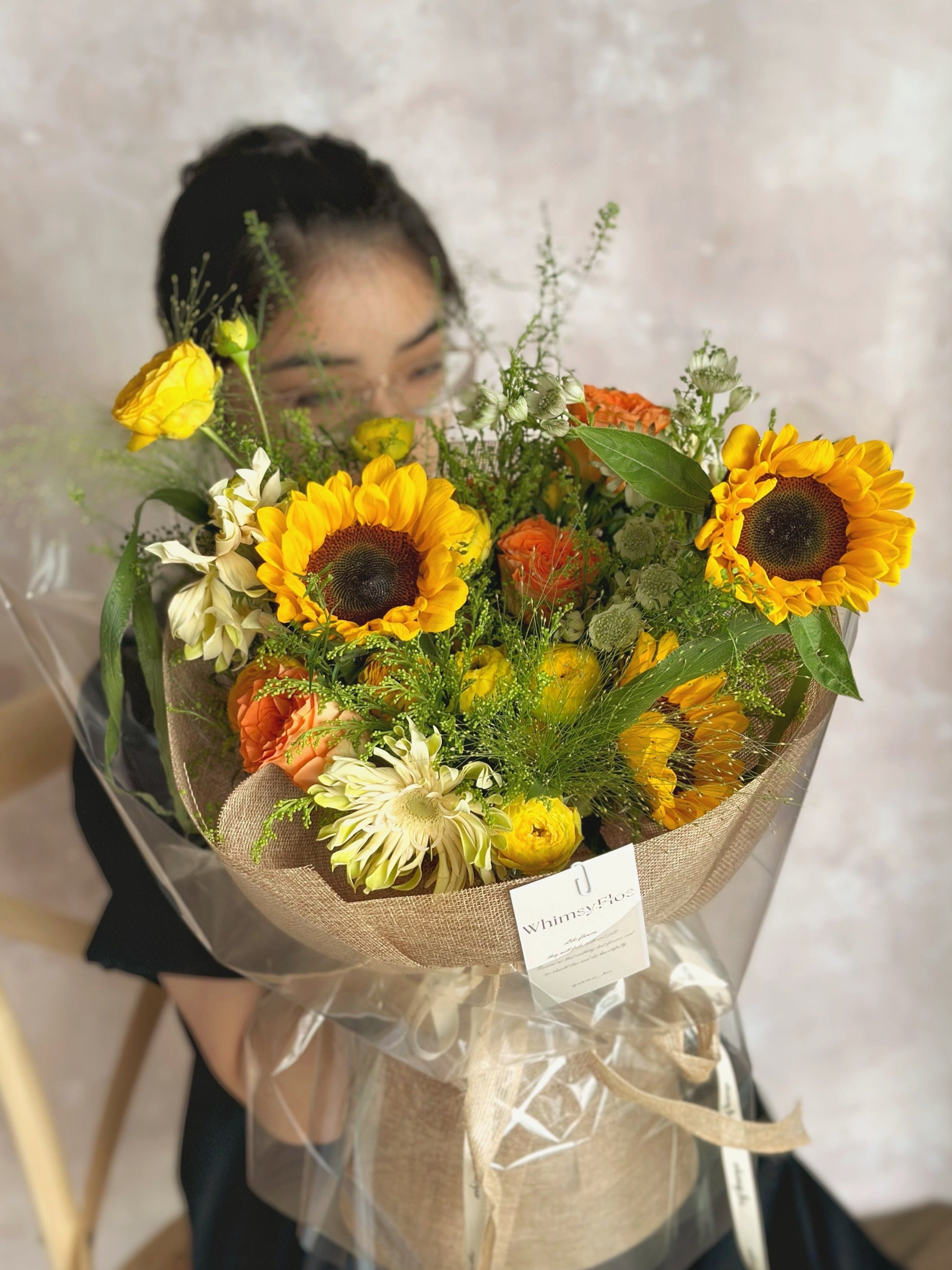 Vibrant sunflowers and roses handtied bouquet in cottage style 