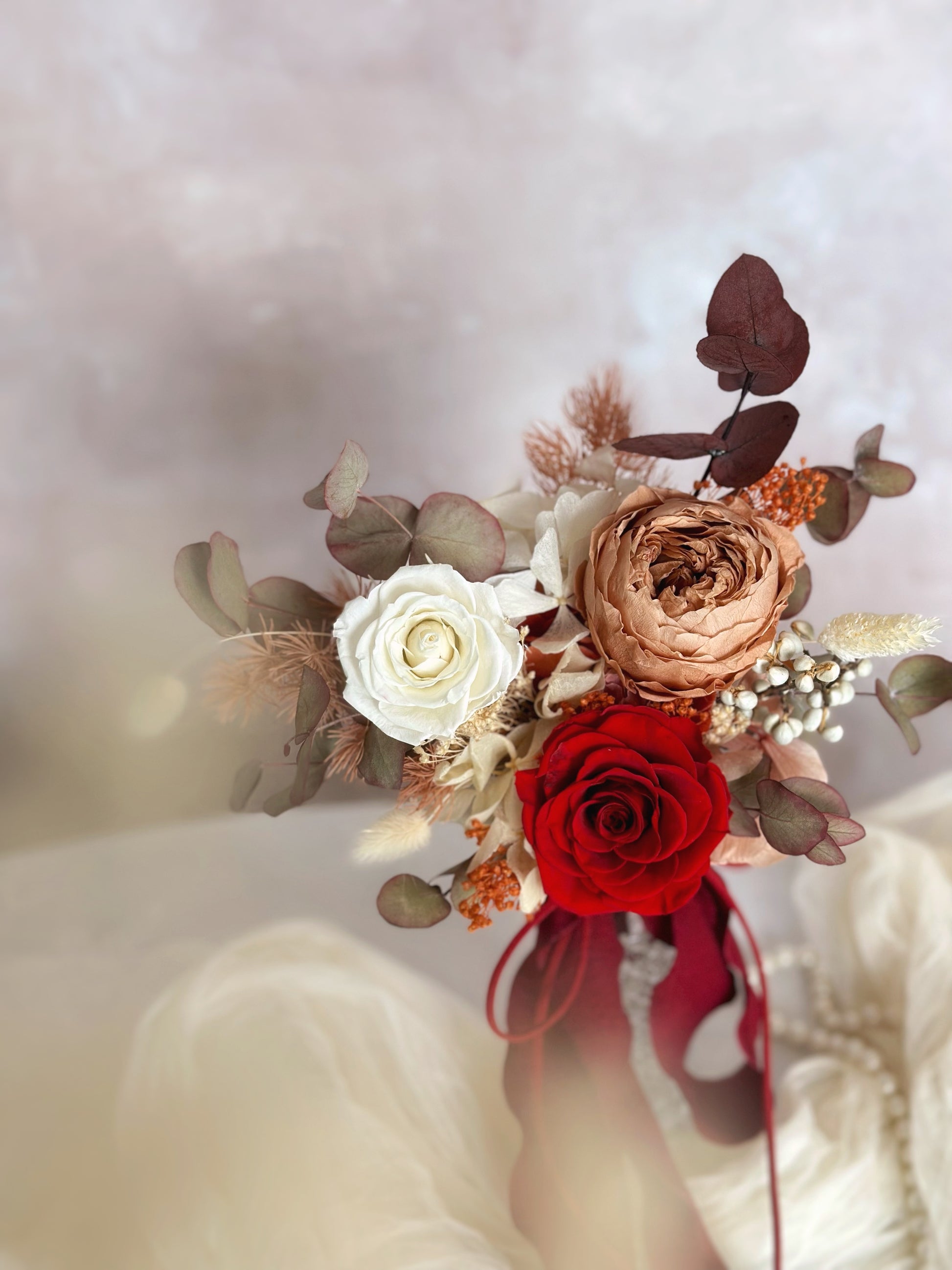 Close up view of preserved flowers bridal bouquet in adorable size. Featuring preserved Austin roses and other fillers 