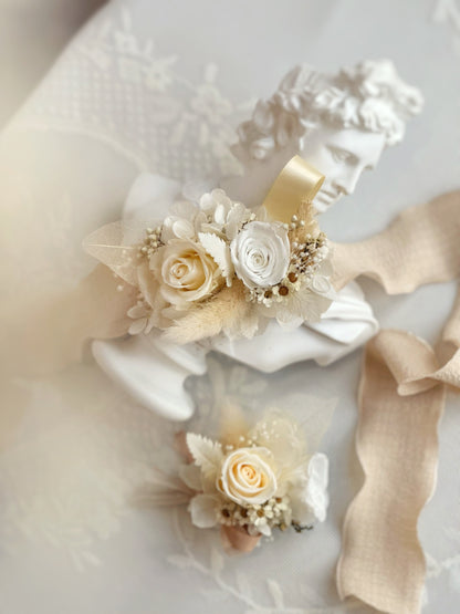 A set of creamy white preserved flowers wrist corsage and boutonniere design 