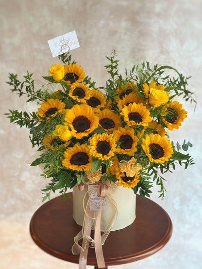 sunflowers bloom box on a wooden table with a neutral background