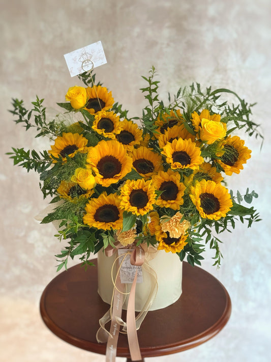 sunflowers bloom box on a wooden table with a neutral background