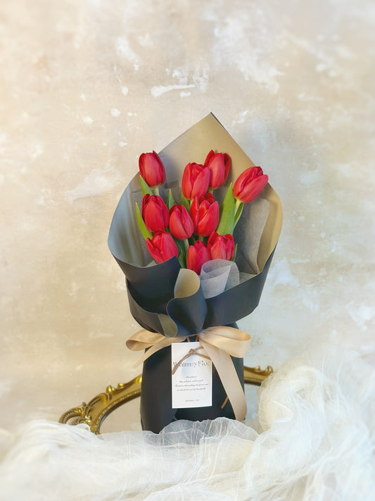 10 stalks of red tulips bouquet in sleek black wrapping style 