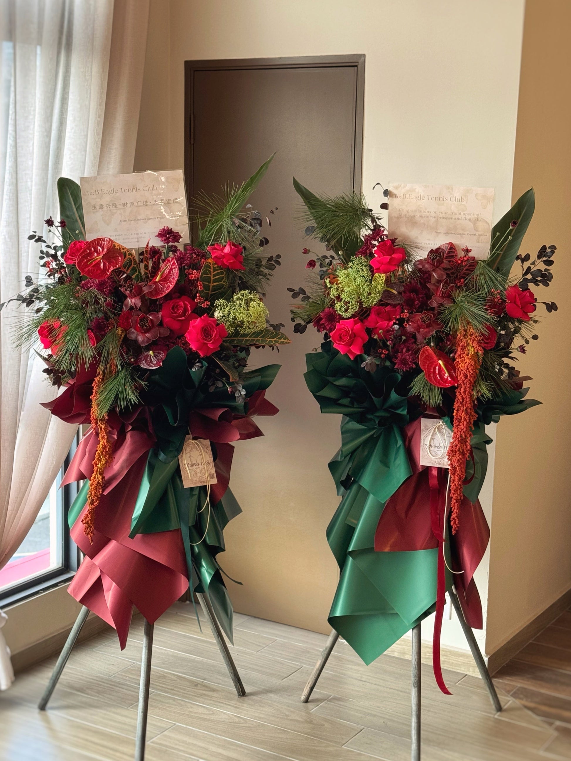 Bold color in green and maroon fresh flowers tropical style grand opening stand in pairs.