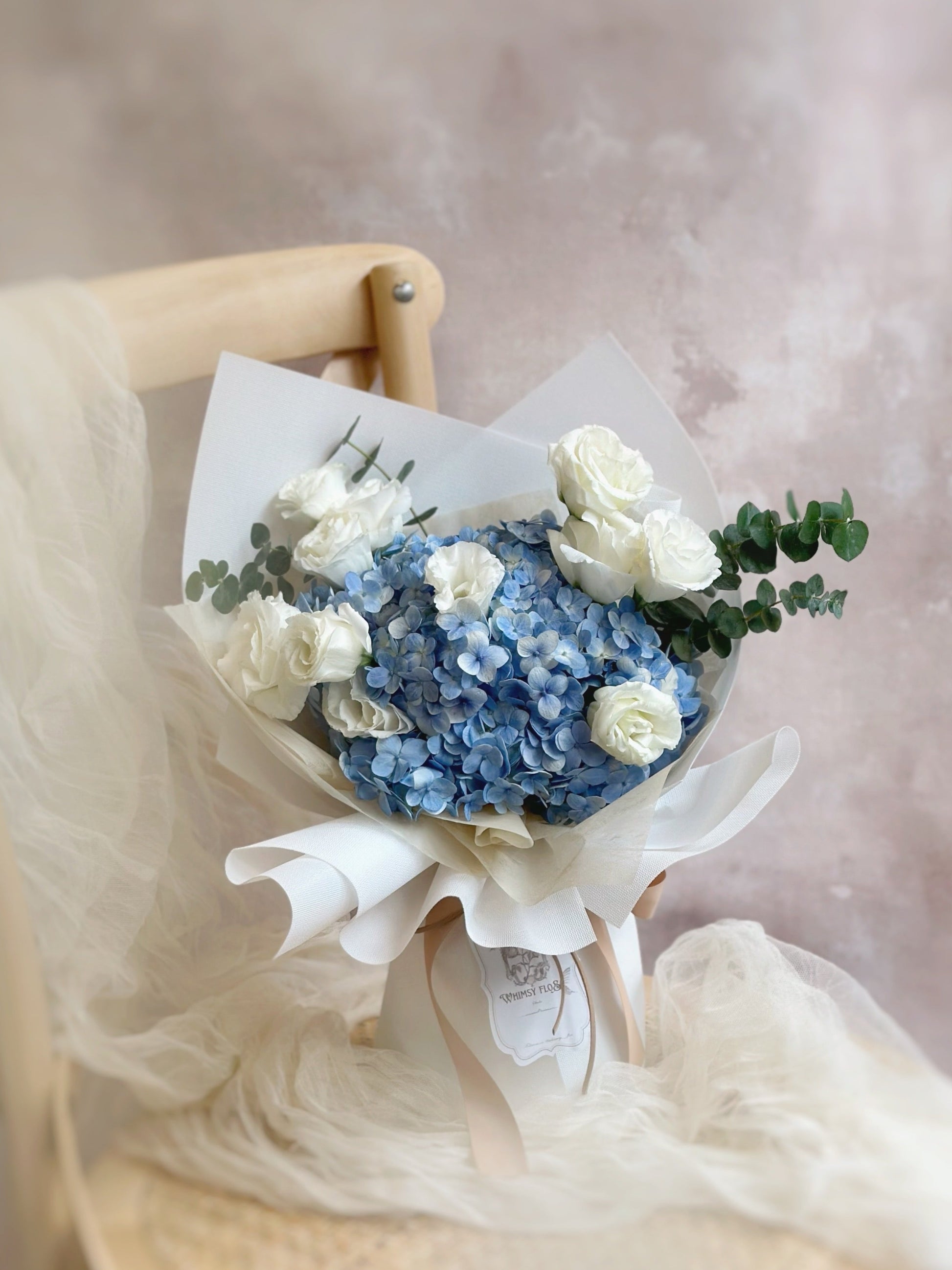 Our "Azure" bouquet captures the essence of tranquility and beauty. Featuring blue hydrangea flower, eustoma flowers and eucalyptus.