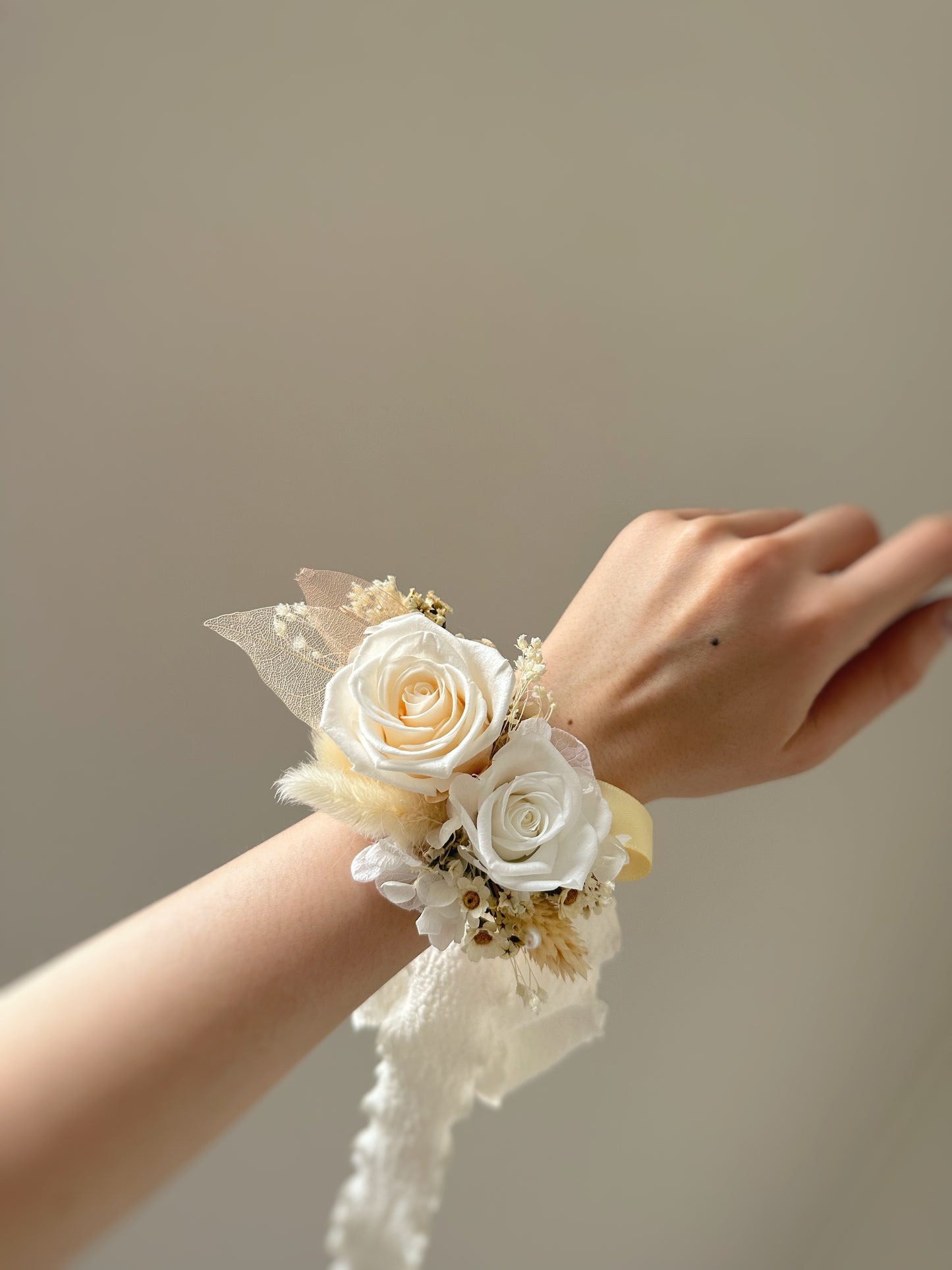 Wearing a preserved roses wrist corsage on the wrist