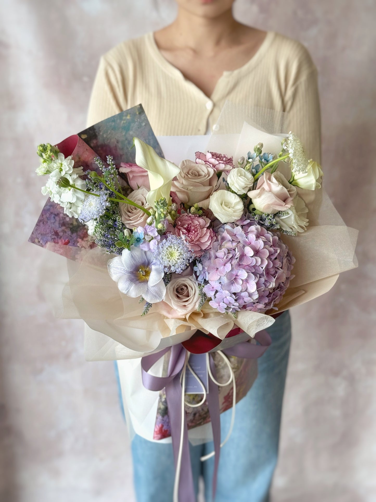 Mystique indulgence fresh flowers grand size bouquet holding by model front view