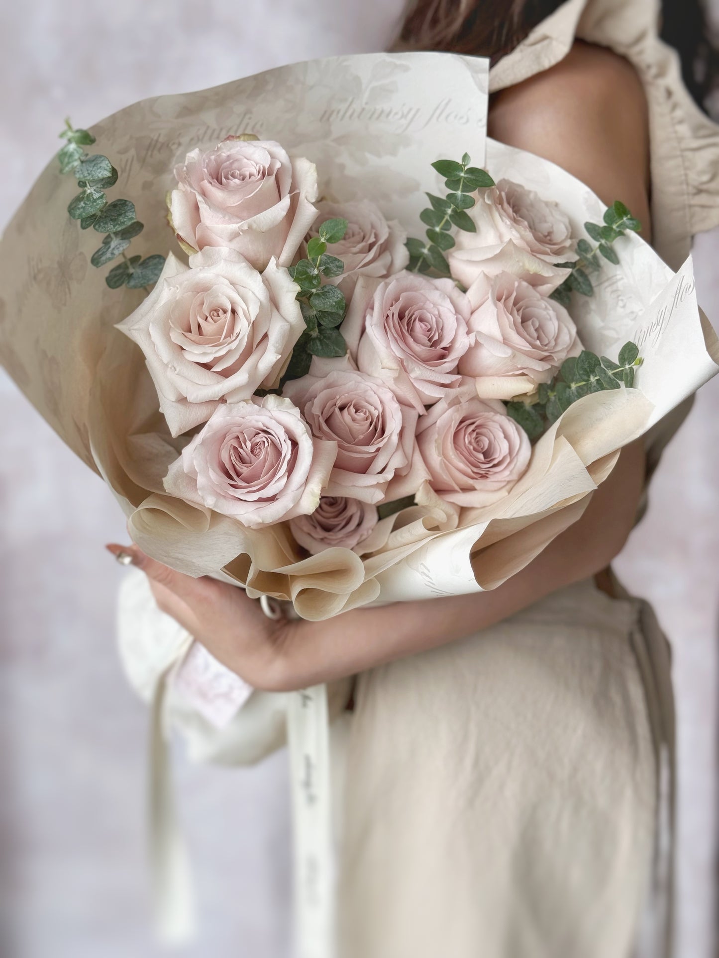 Quicksand fresh flowers handtied bouquet holding the bouquet, close view