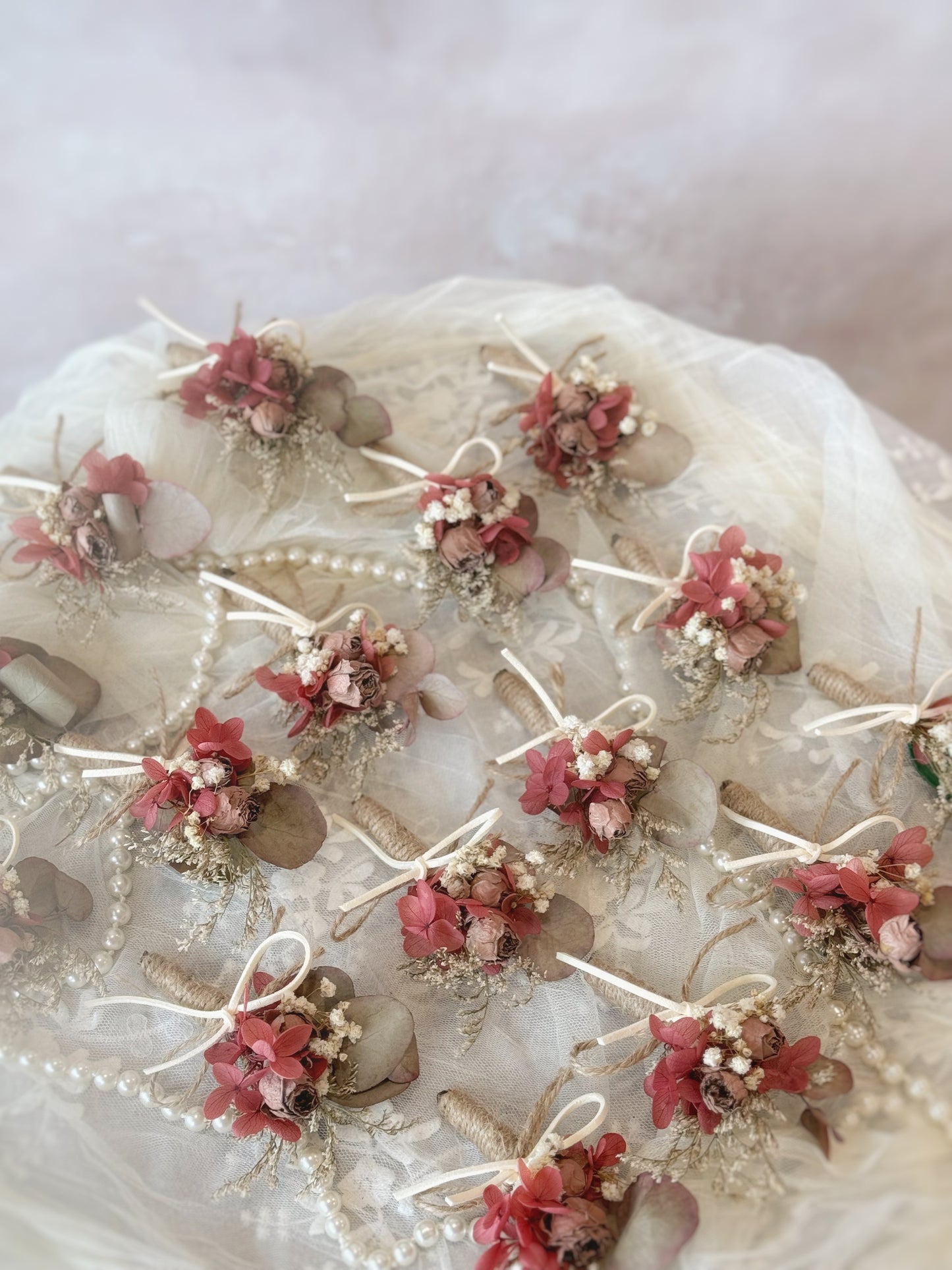 Rustique Rose tinted preserved and dried flowers boutonniere on the table