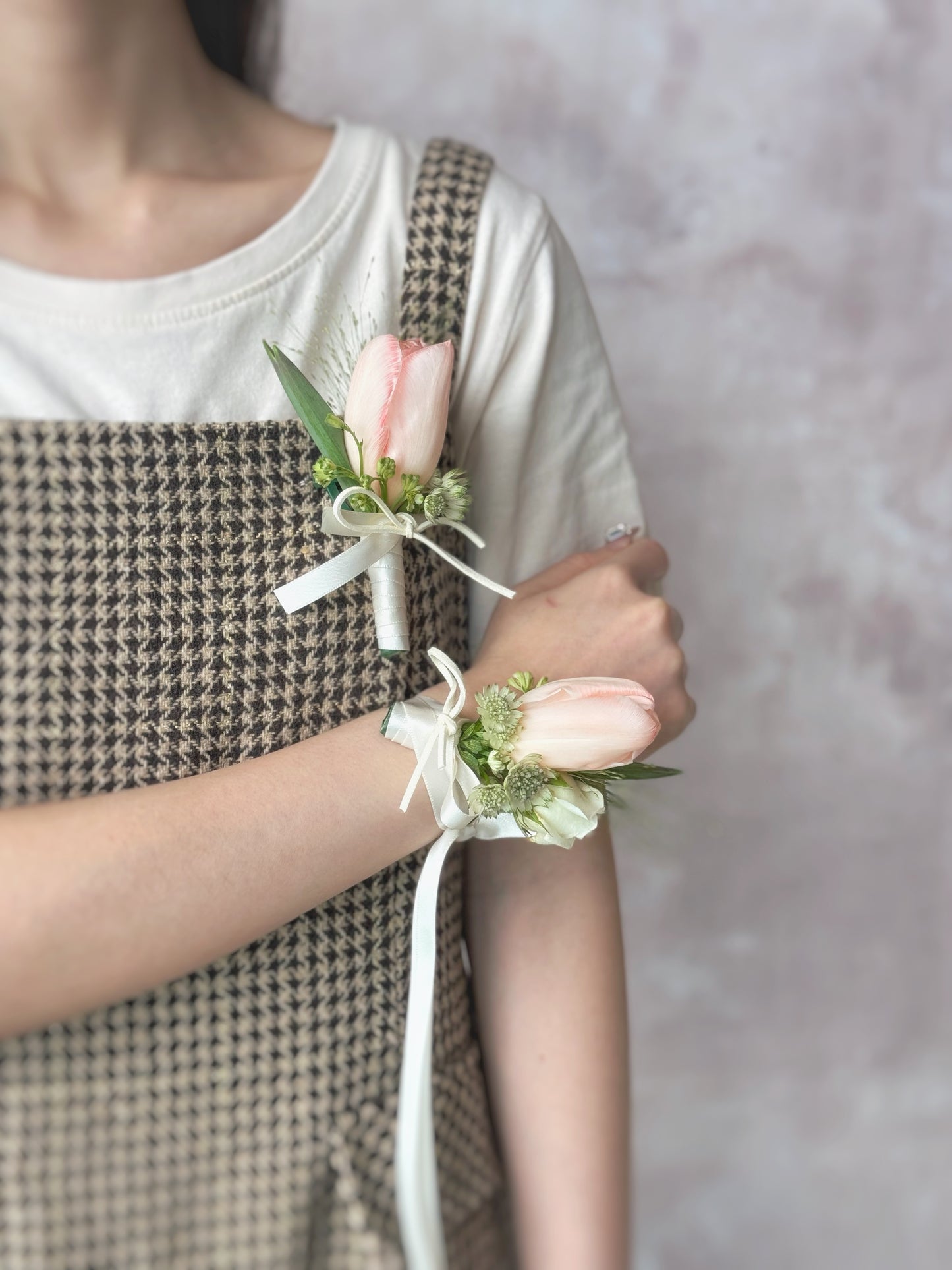 Sample photo of a model wearing Sage blush tulip boutonniere and tulip wrist corsage