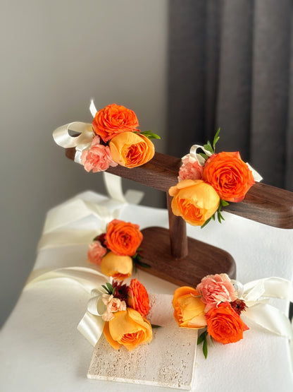 Multiple Sienna Glow wrist corsages arranged neatly on a table, perfect for an autumnal wedding theme.