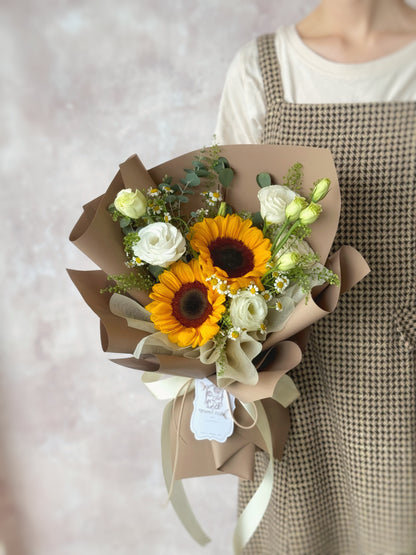 Stella fresh flowers handtied bouquet brown wrapping sunflower mix holding by model