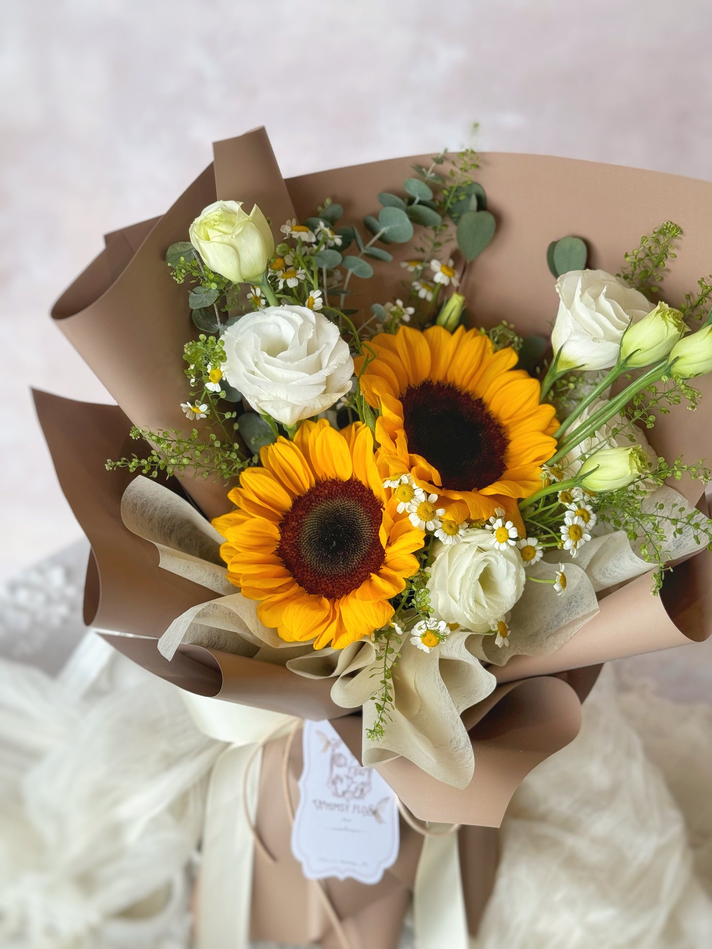 Stella fresh flowers handtied bouquet brown wrapping sunflower mix top view